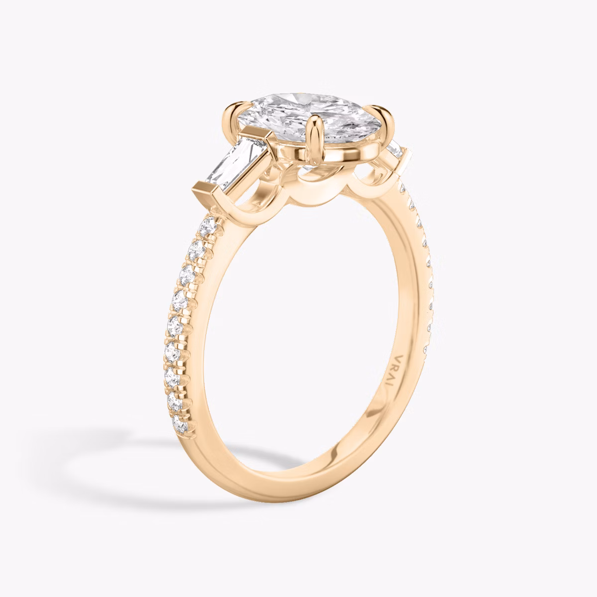 The Three Stone | Oval | 14k | Rose Gold | bandAccent: Pavé | sideStoneCarat: 0.10ct | sideStoneShape: Tapered Baguette | diamondOrientation: vertical | caratWeight: other