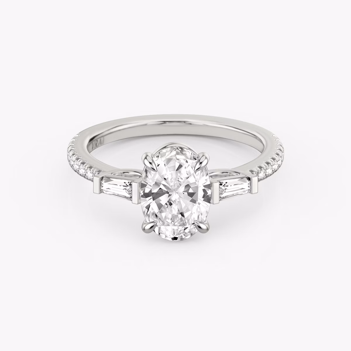 The Three Stone | Oval | Platinum | bandAccent: Pavé | sideStoneCarat: 0.10ct | sideStoneShape: Tapered Baguette | diamondOrientation: vertical | caratWeight: other
