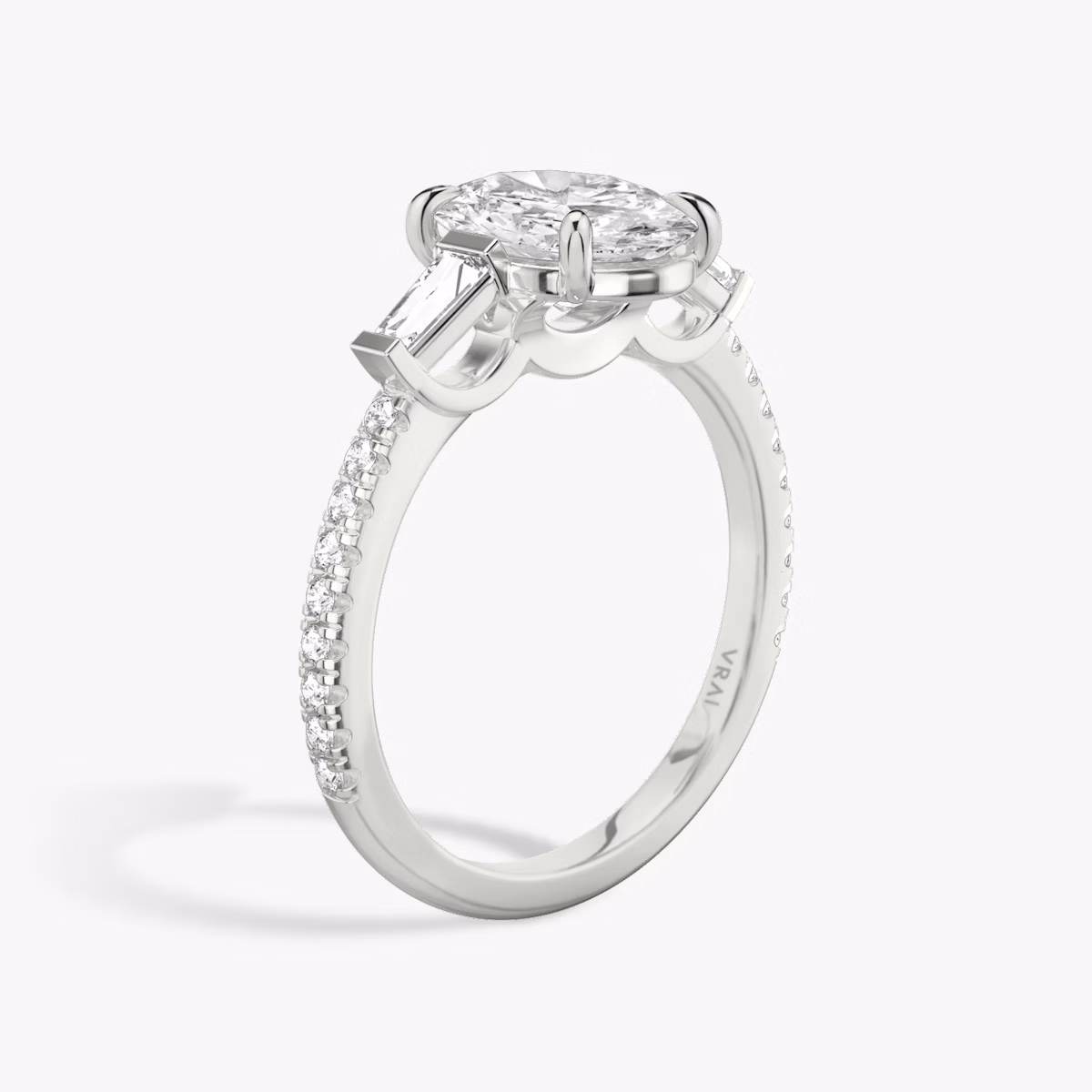 The Three Stone | Oval | Platinum | bandAccent: Pavé | sideStoneCarat: 0.10ct | sideStoneShape: Tapered Baguette | diamondOrientation: vertical | caratWeight: other