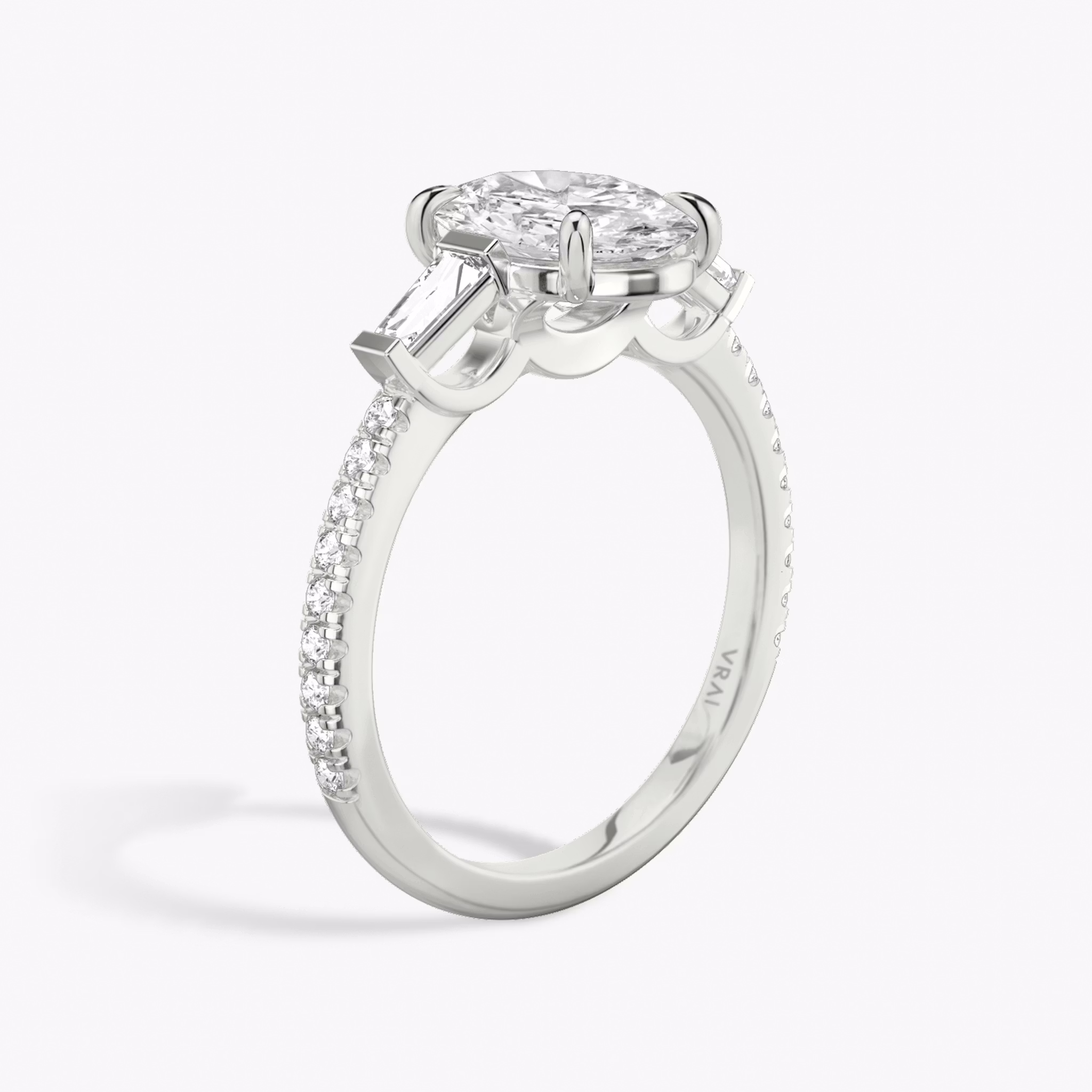 The Three Stone | Oval | 18k | White Gold | bandAccent: Pavé | sideStoneCarat: 0.10ct | sideStoneShape: Tapered Baguette | diamondOrientation: vertical | caratWeight: other