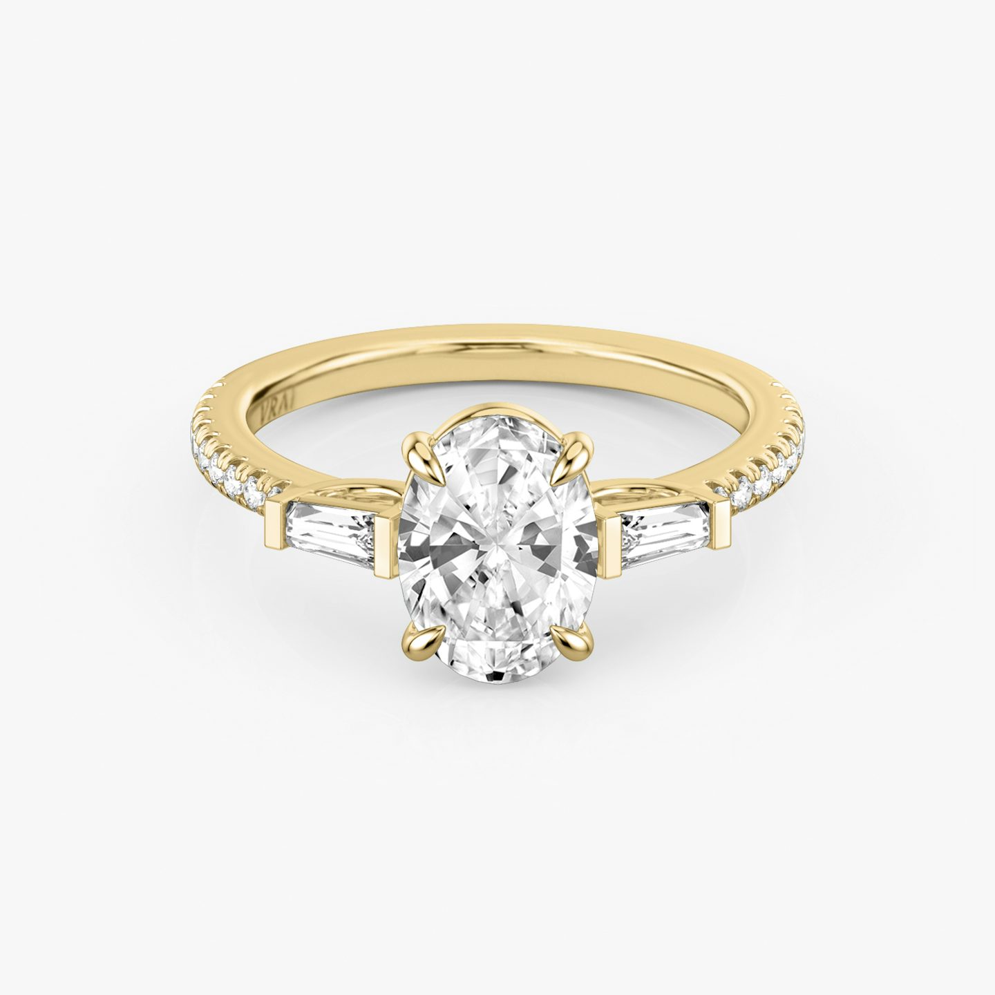 The Three Stone | Oval | 18k | Yellow Gold | bandAccent: Pavé | sideStoneCarat: 0.10ct | sideStoneShape: Tapered Baguette | diamondOrientation: vertical | caratWeight: other