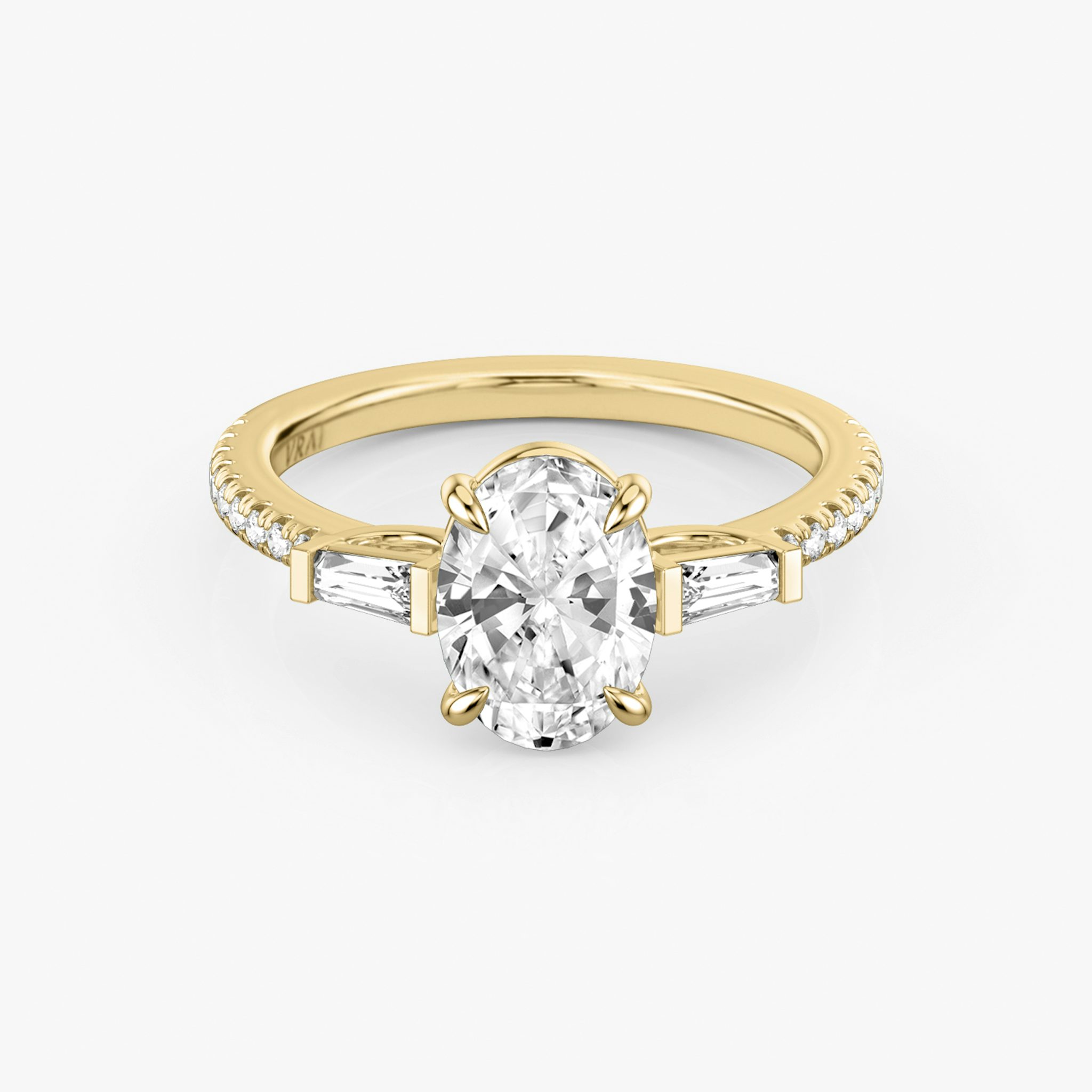 The Three Stone | Oval | 18k | Yellow Gold | bandAccent: Pavé | sideStoneCarat: 0.10ct | sideStoneShape: Tapered Baguette | diamondOrientation: vertical | caratWeight: other