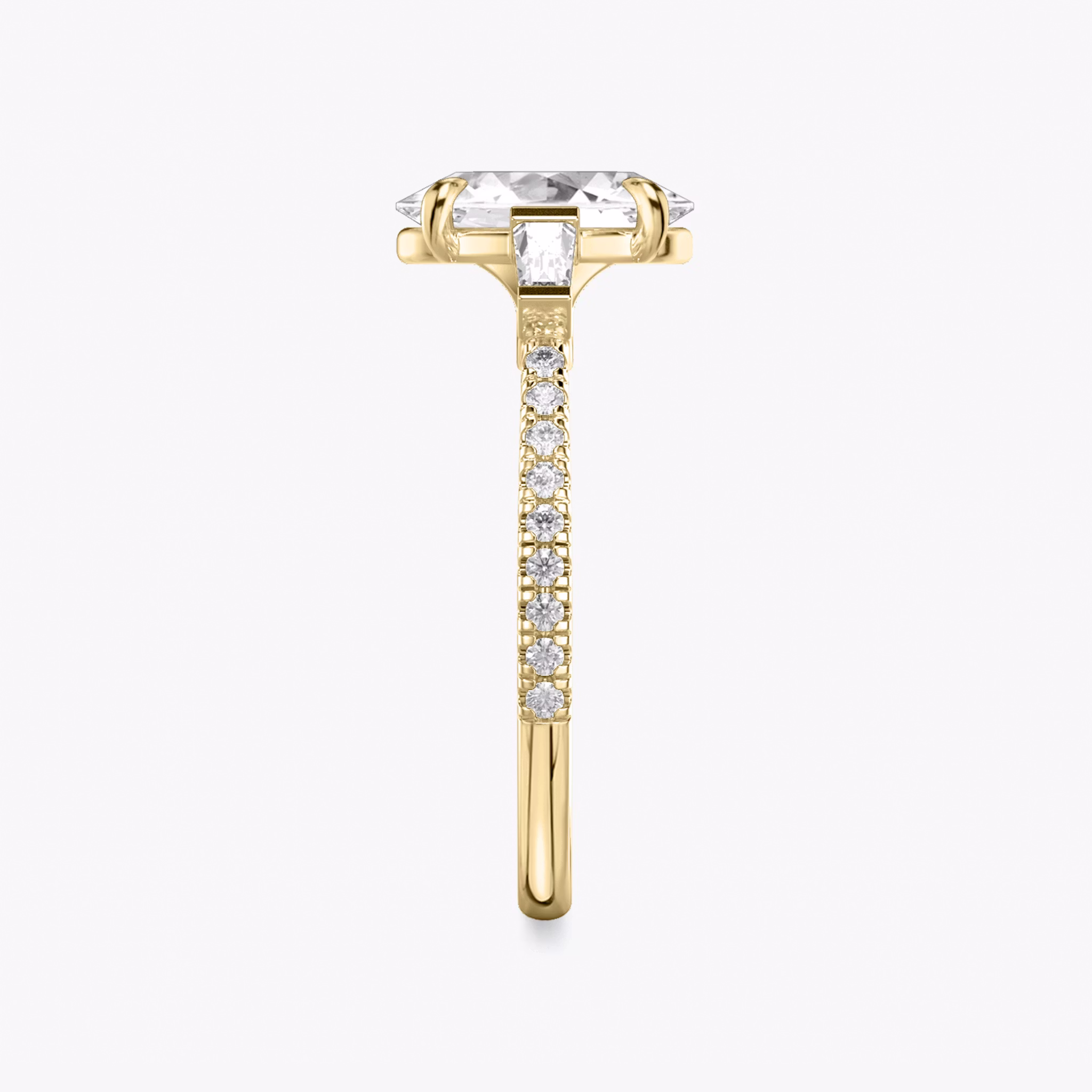 The Three Stone | Oval | 18k | Yellow Gold | bandAccent: Pavé | sideStoneCarat: 0.10ct | sideStoneShape: Tapered Baguette | diamondOrientation: vertical | caratWeight: other