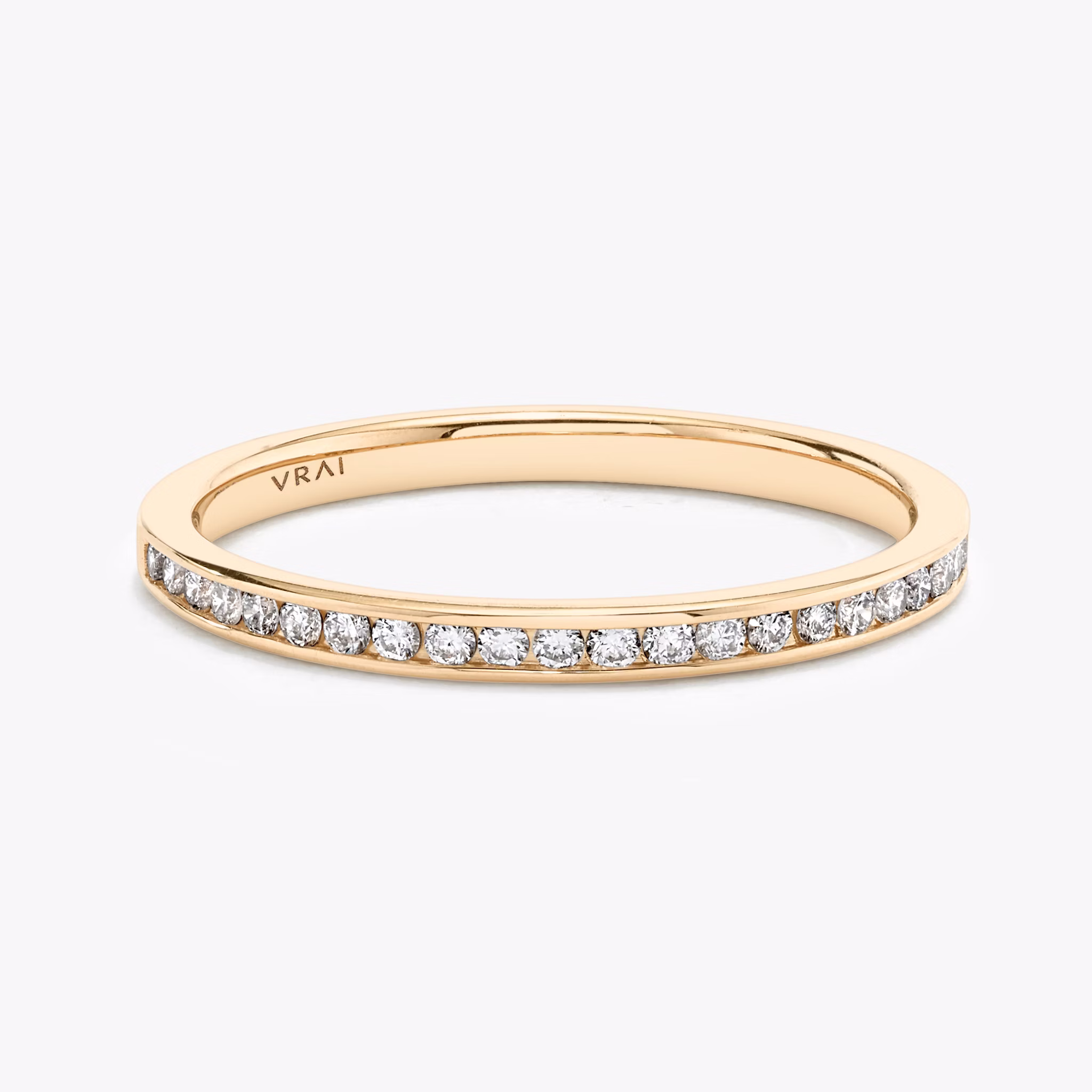 Rose gold half-eternity band with round diamonds in a shared prong setting, displayed on white background.