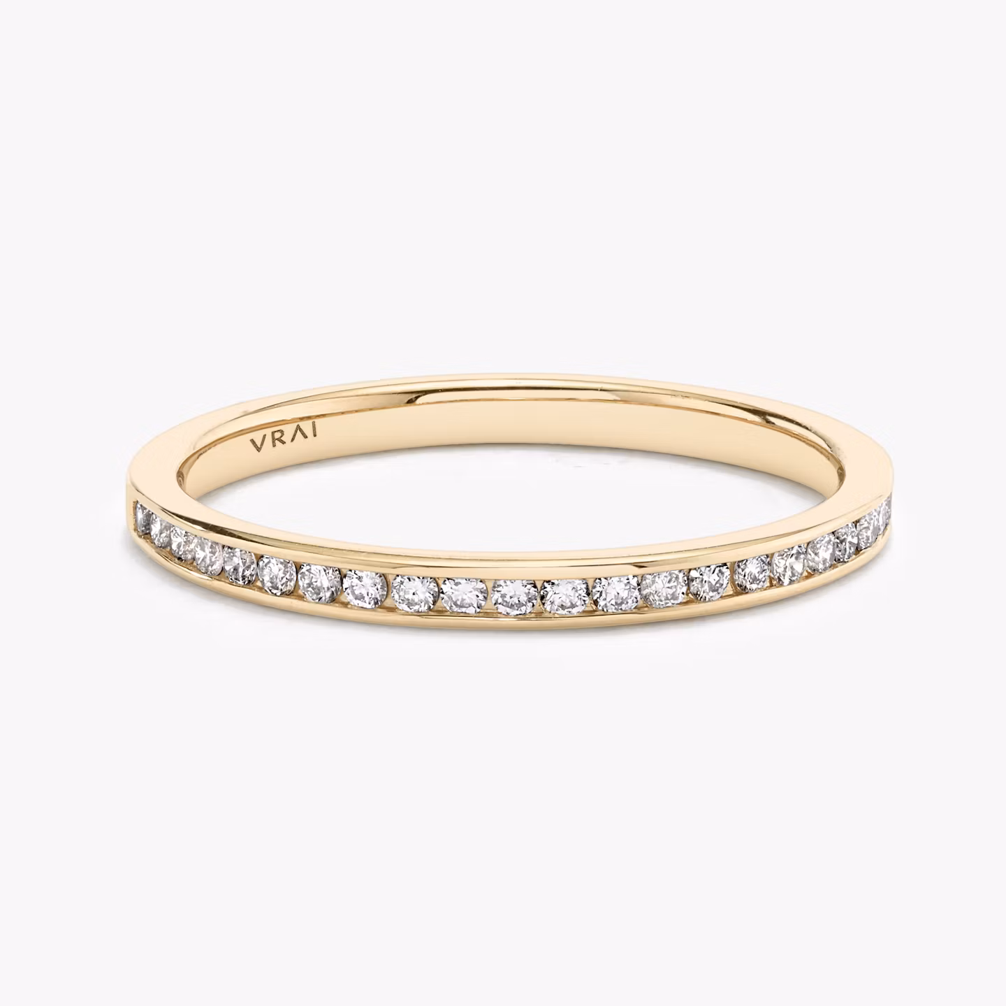 Rose gold half-eternity band with round diamonds in a shared prong setting, displayed on white background.