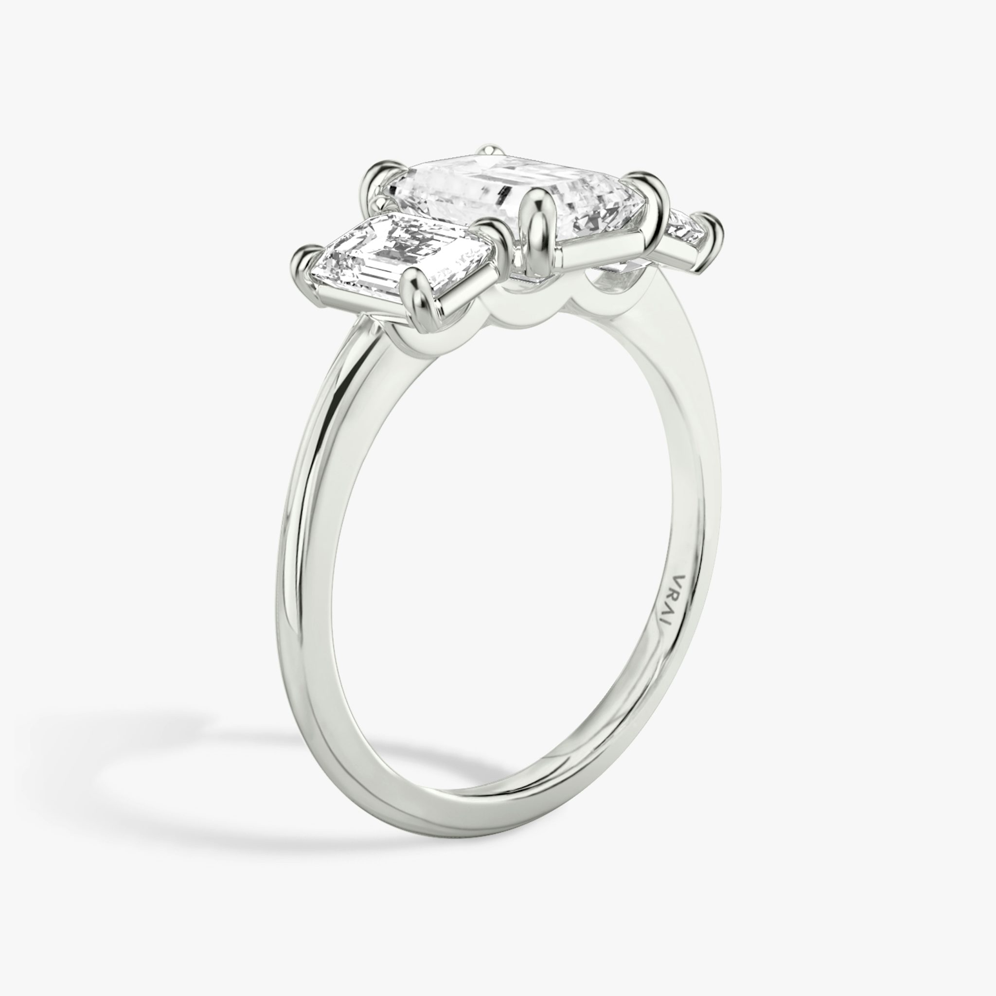 The Three Stone | Emerald | 18k | White Gold | bandAccent: Plain | sideStoneCarat: 0.50ct | sideStoneShape: Emerald | diamondOrientation: vertical | caratWeight: other