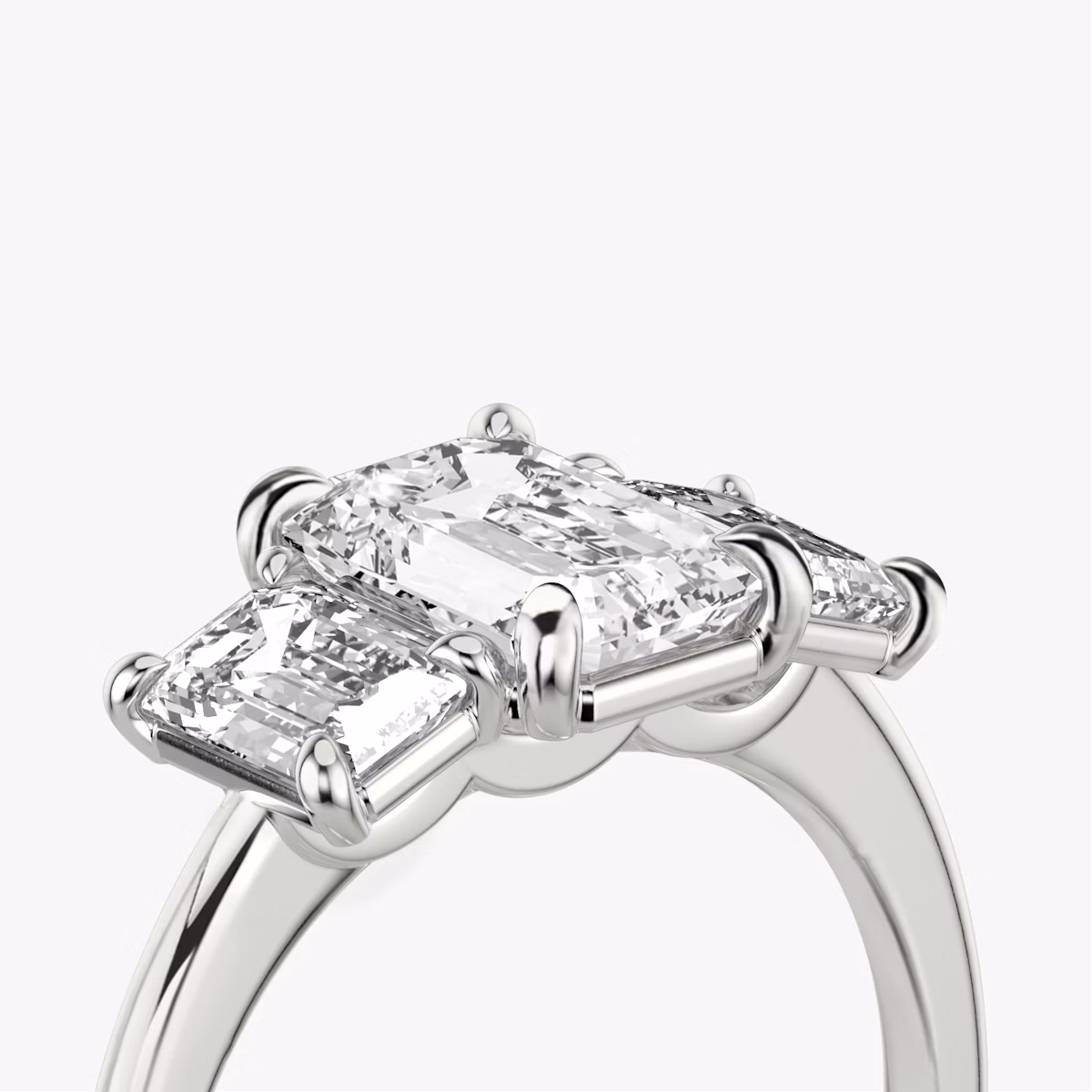The Three Stone | Emerald | Platinum | bandAccent: Plain | sideStoneCarat: 0.50ct | sideStoneShape: Emerald | diamondOrientation: vertical | caratWeight: other