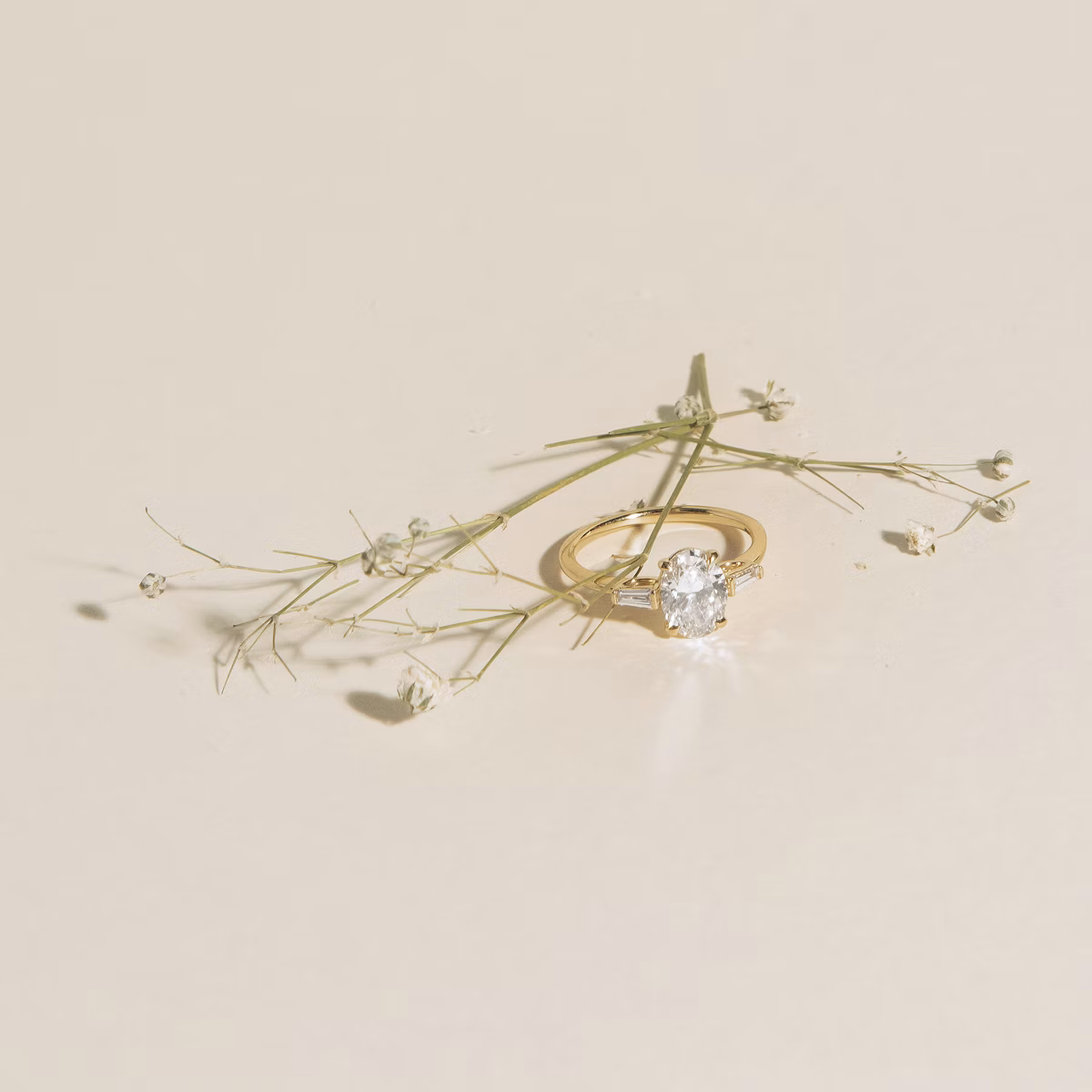 The Three Stone | Oval | 14k | Rose Gold | bandAccent: Plain | sideStoneCarat: 0.10ct | sideStoneShape: Tapered Baguette | diamondOrientation: vertical | caratWeight: other