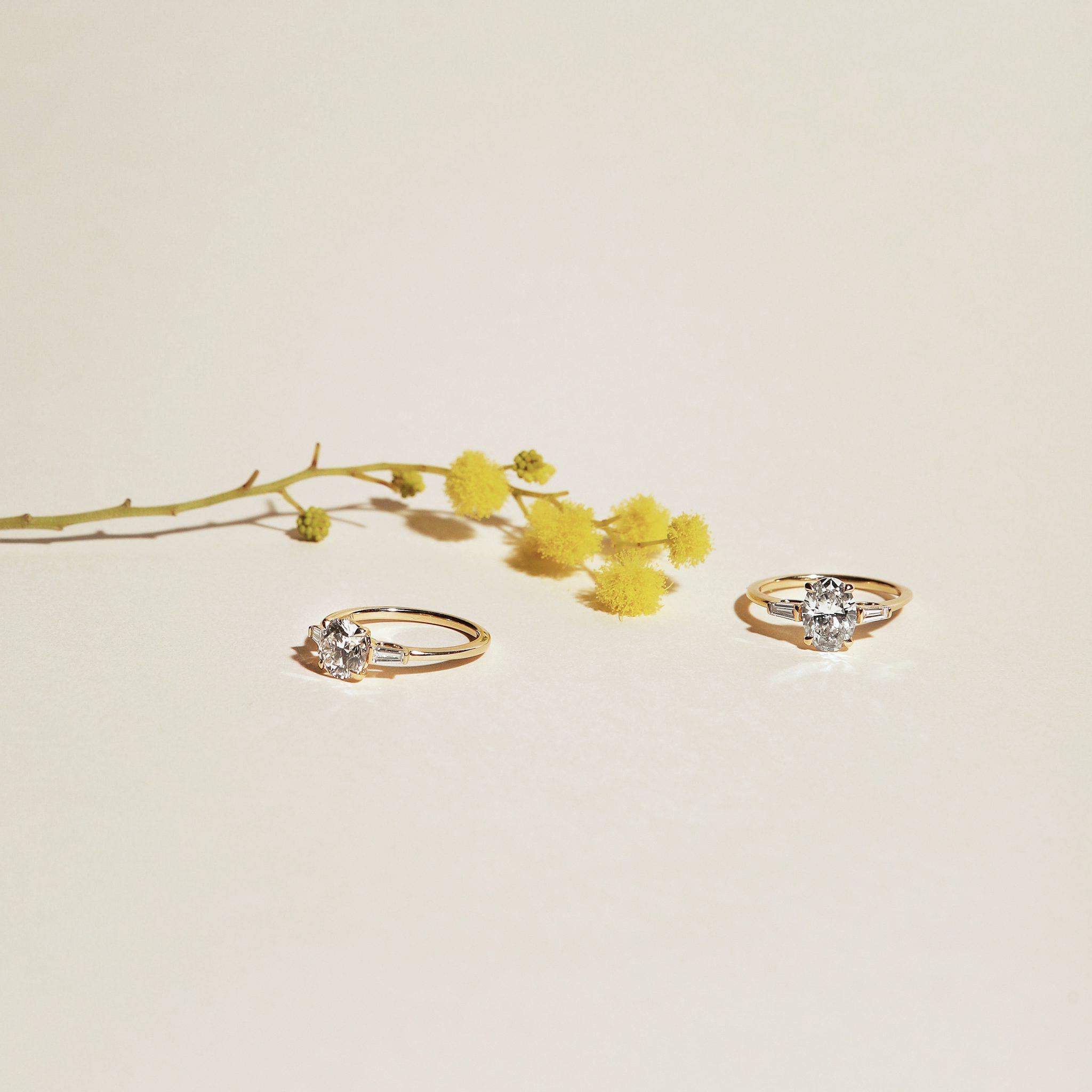 The Three Stone | Round Brilliant | 18k | Yellow Gold | bandAccent: Plain | caratWeight: other | sideStoneCarat: 0.10ct | sideStoneShape: Tapered Baguette | diamondOrientation: vertical