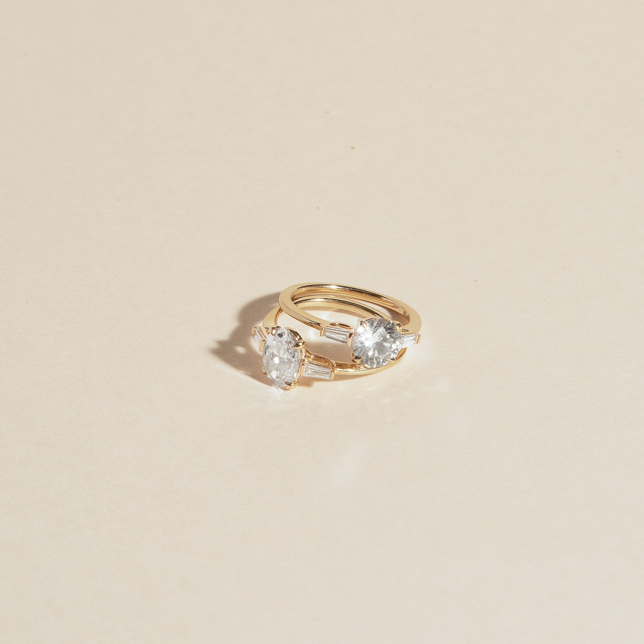 The Three Stone | Round Brilliant | 18k | Yellow Gold | bandAccent: Plain | caratWeight: other | sideStoneCarat: 0.10ct | sideStoneShape: Tapered Baguette | diamondOrientation: vertical