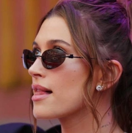 A close-up image of Hailey Bieber wearing a pair of Solitaire Studs by VRAI.