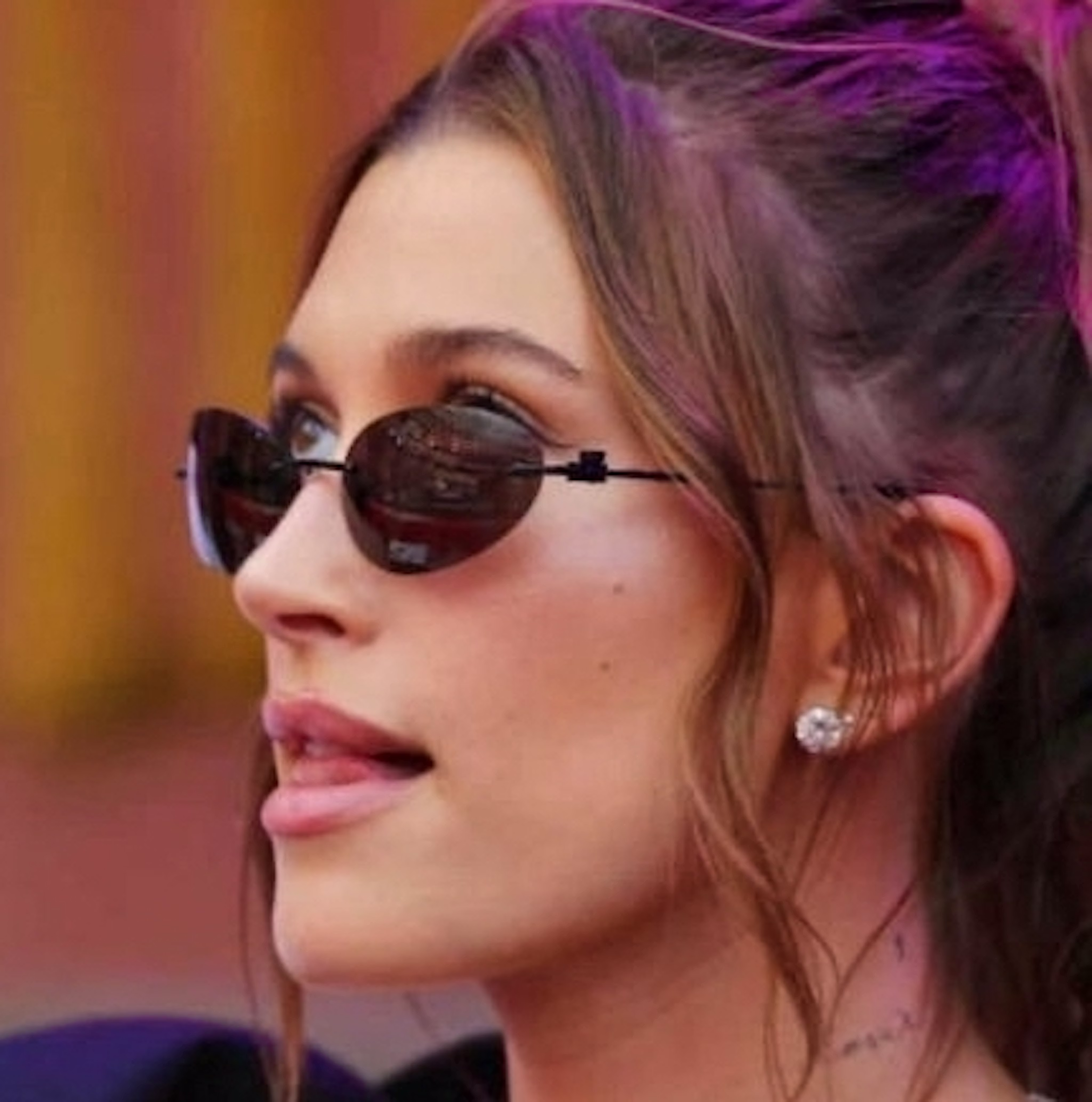 A close-up image of Hailey Bieber wearing a pair of Solitaire Studs by VRAI.