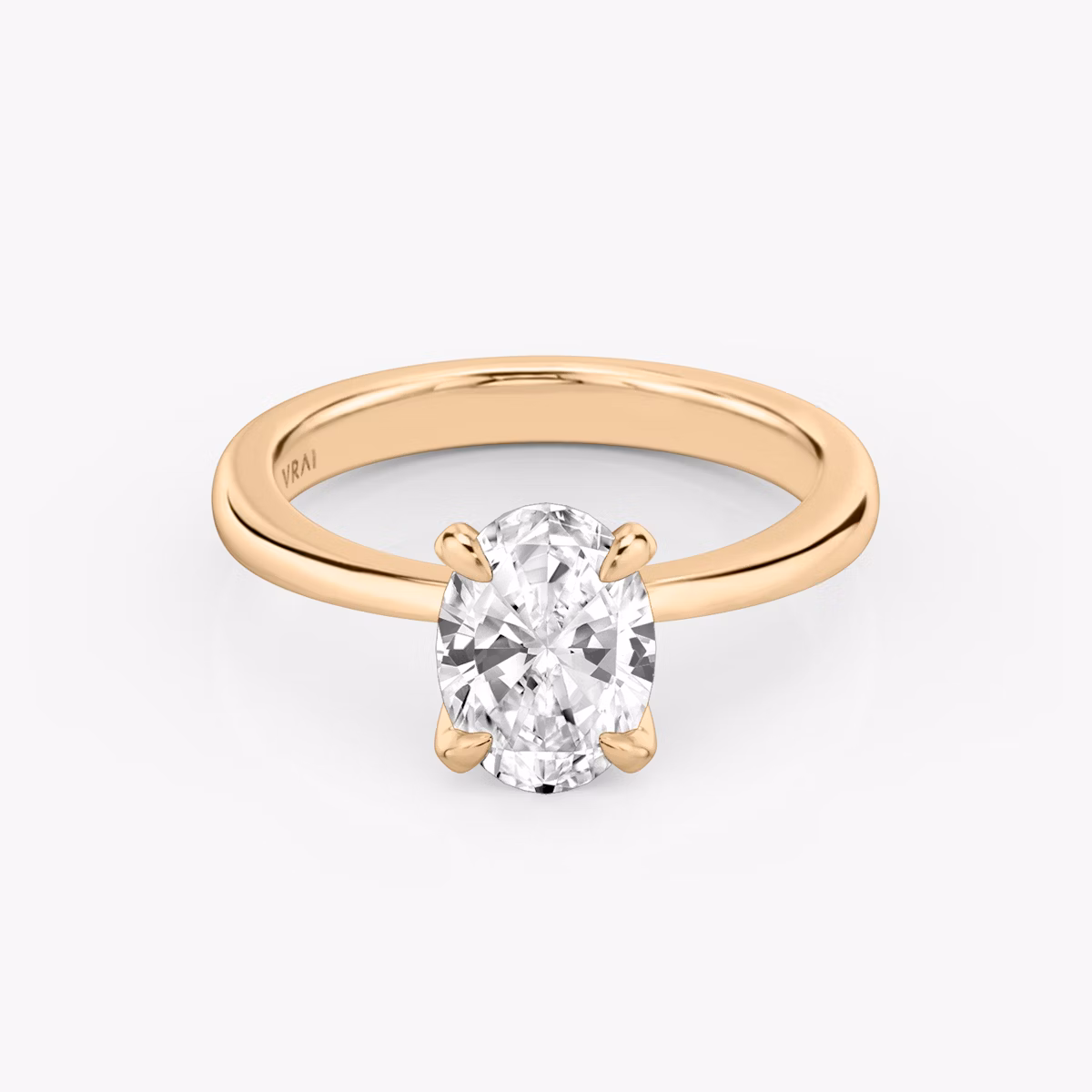 Round rose gold ring with an oval diamond