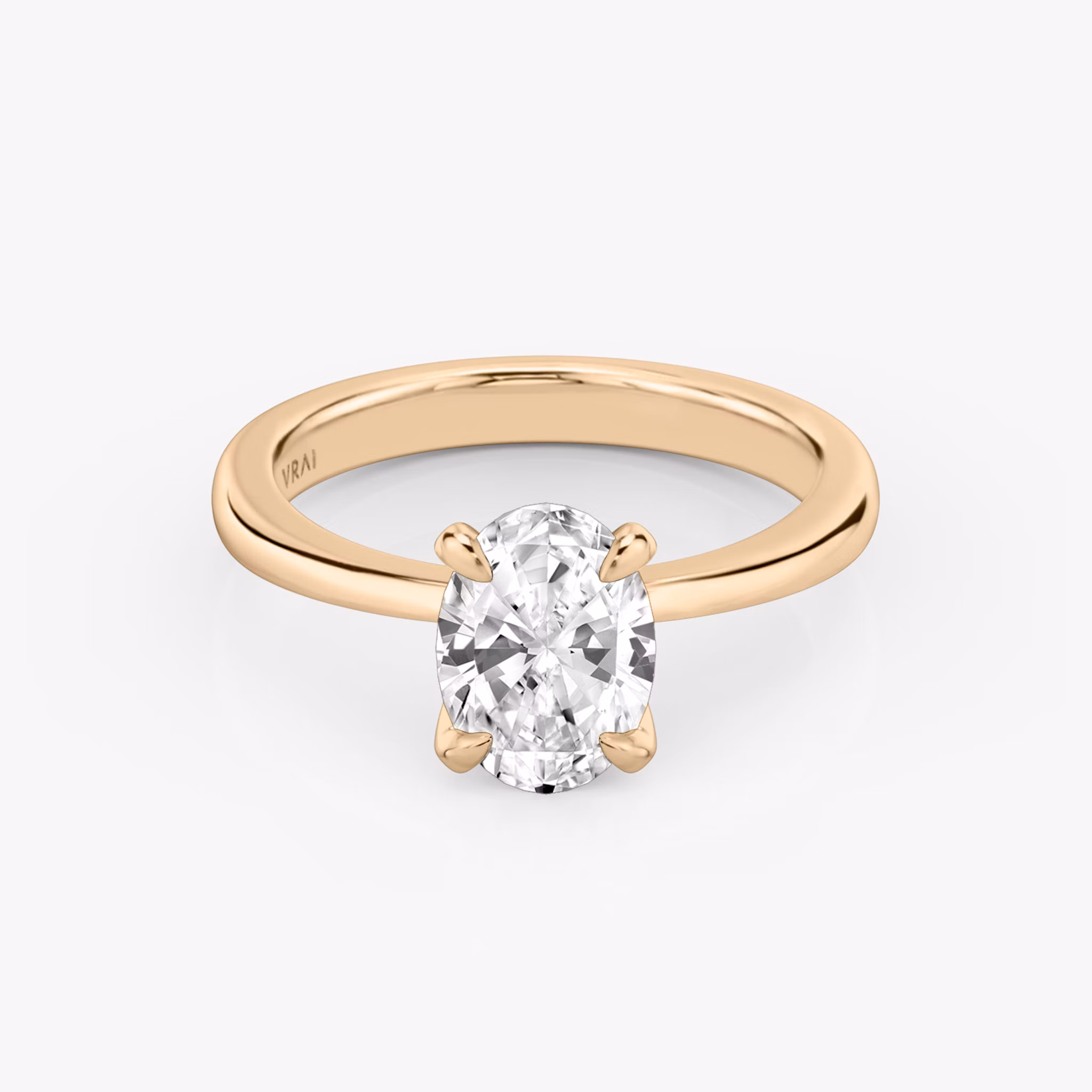 Round rose gold ring with an oval diamond