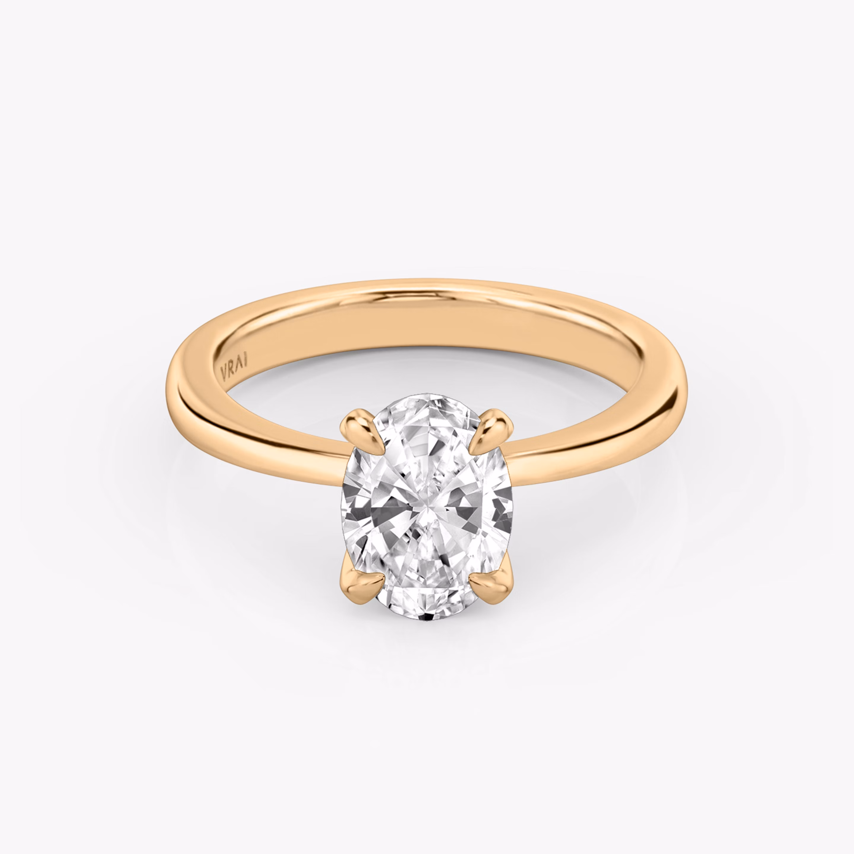 Round rose gold ring with an oval diamond