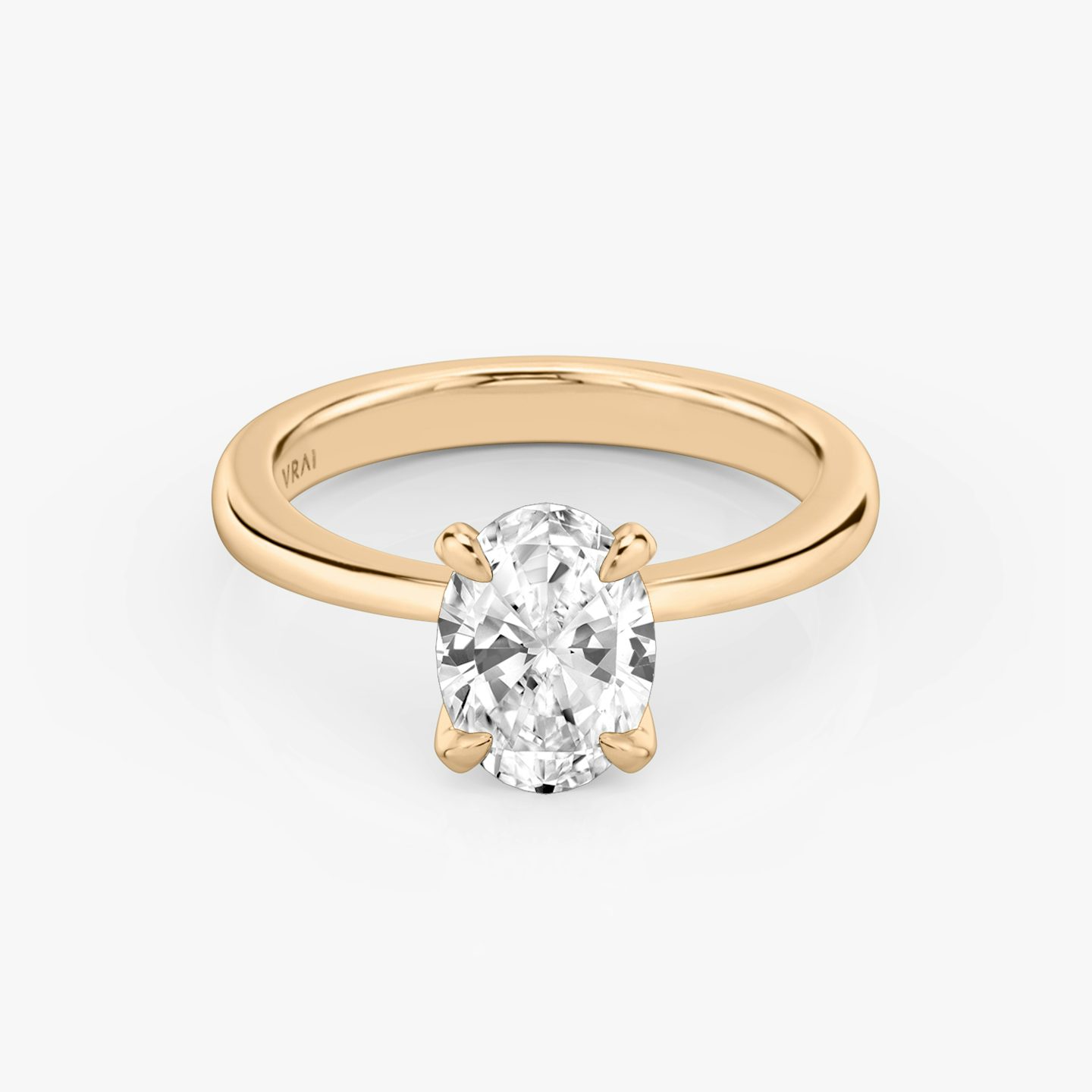 Round rose gold ring with an oval diamond