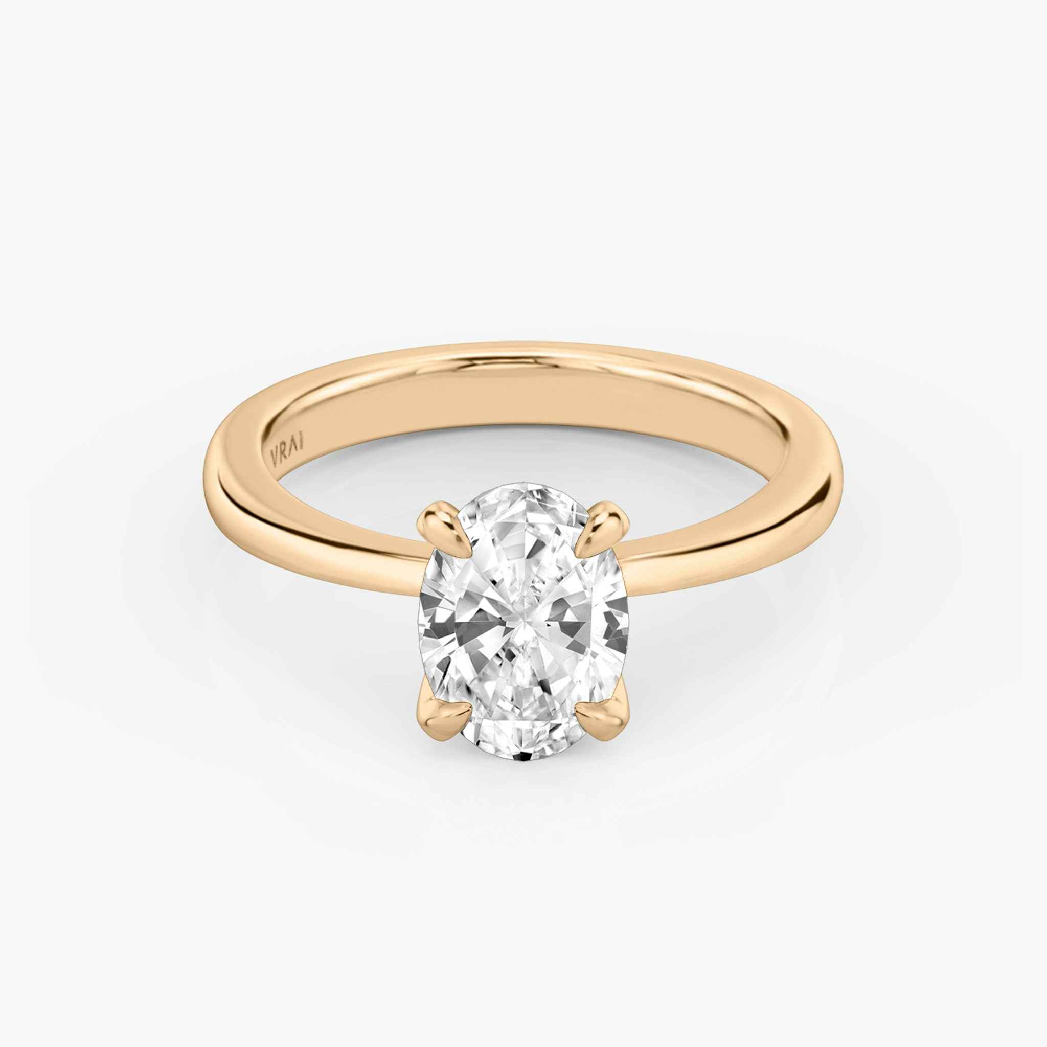 Round rose gold ring with an oval diamond