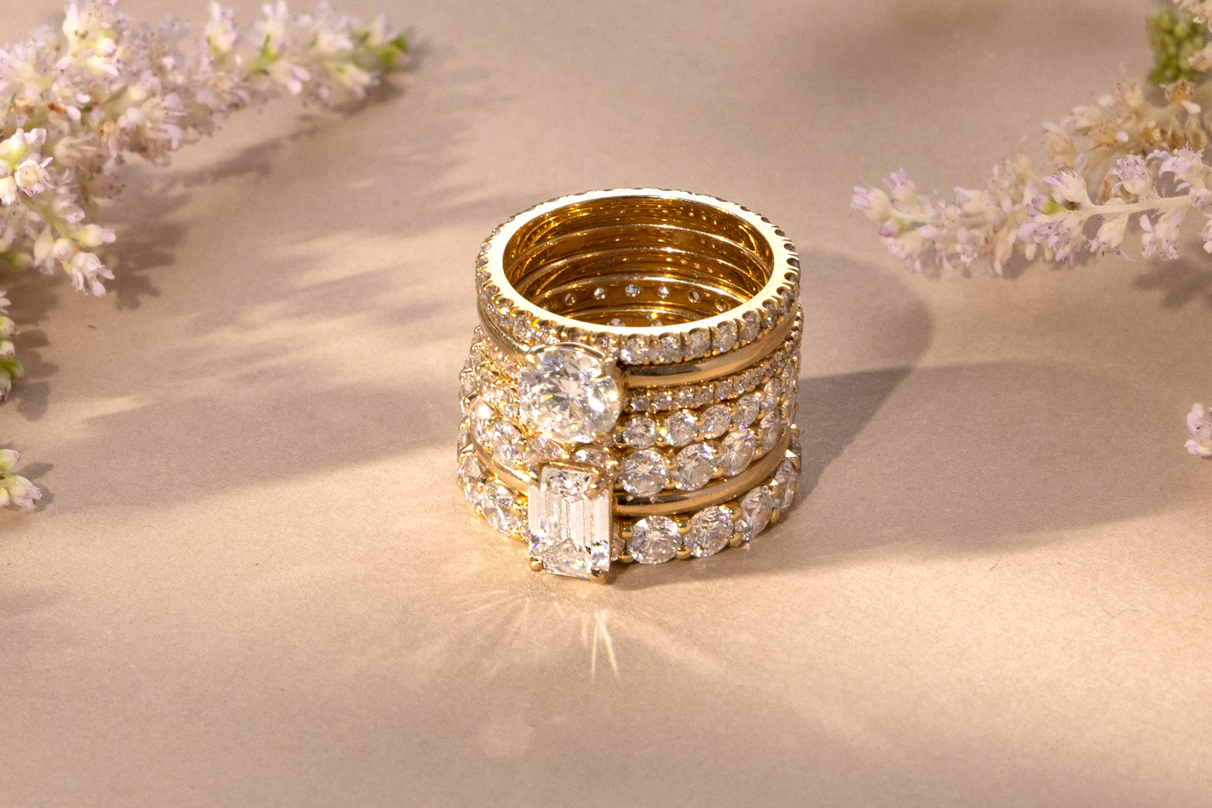 A stack of gold rings with VRAI created diamonds.