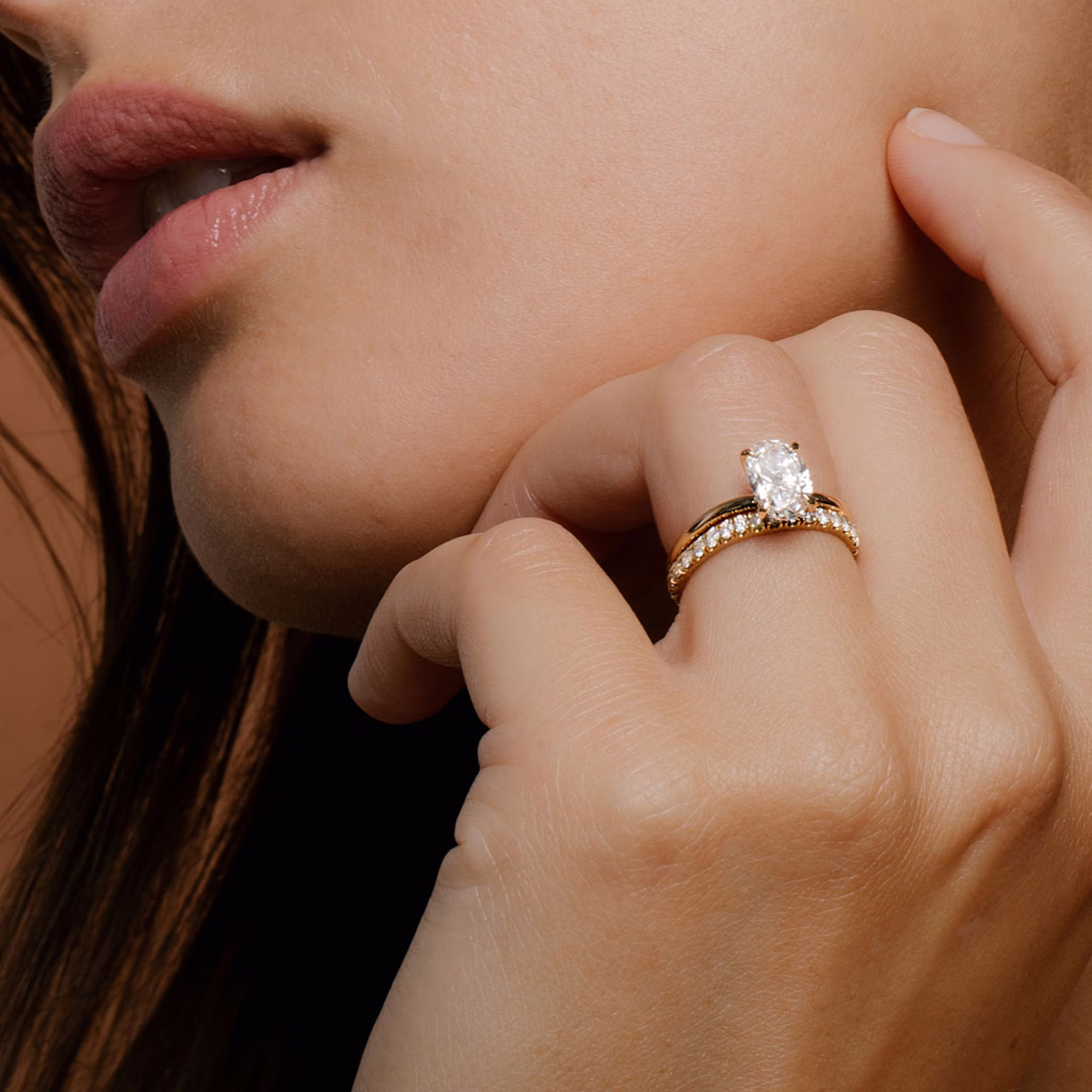 Close up of a Yellow Gold Oval Engagement Rings and Wedding Band