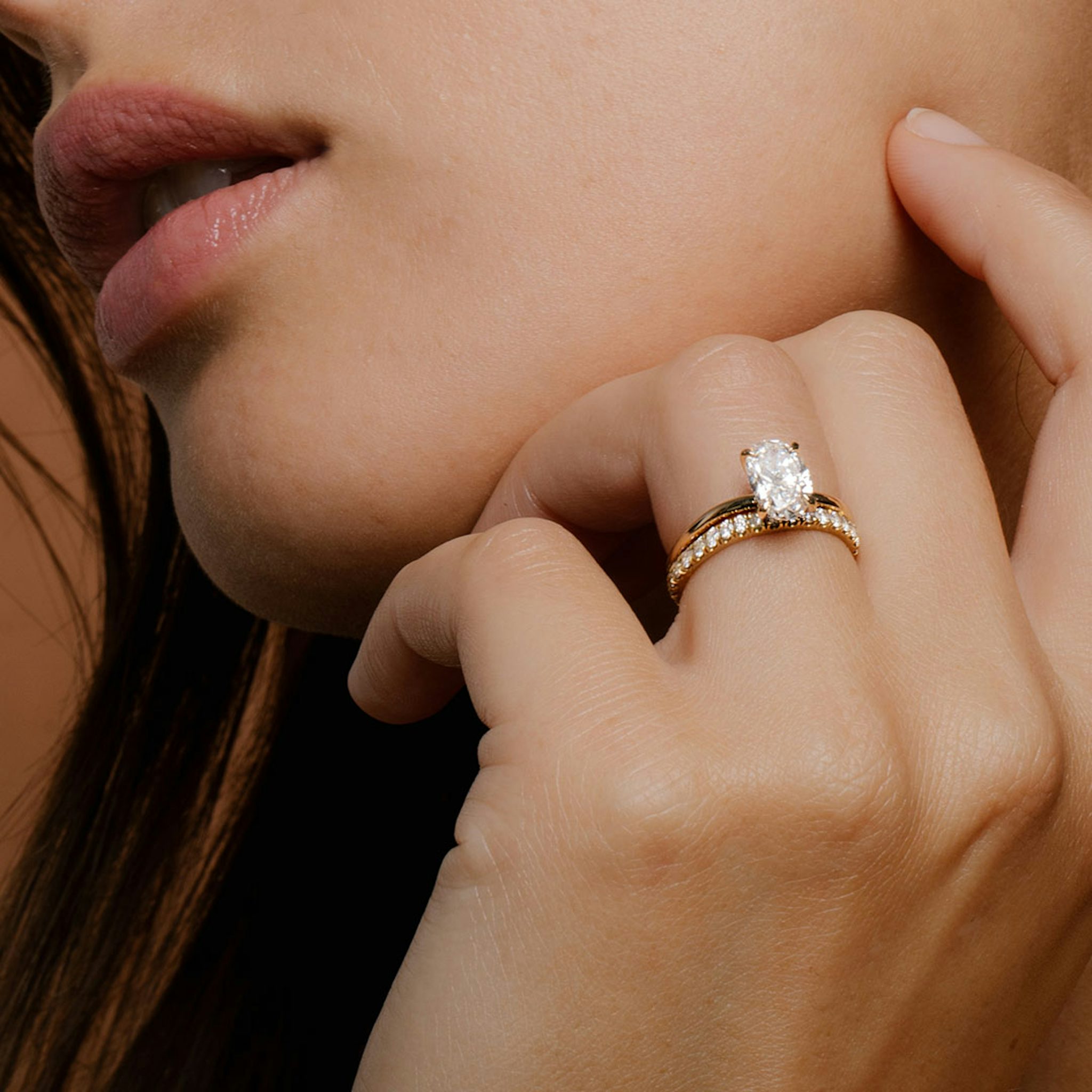 Close up of a Yellow Gold Oval Engagement Rings and Wedding Band
