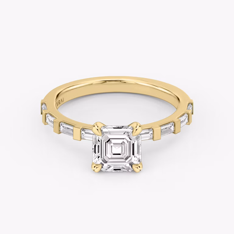 The Baguette Bar Asscher Yellow Gold Engagement Ring laying flat.