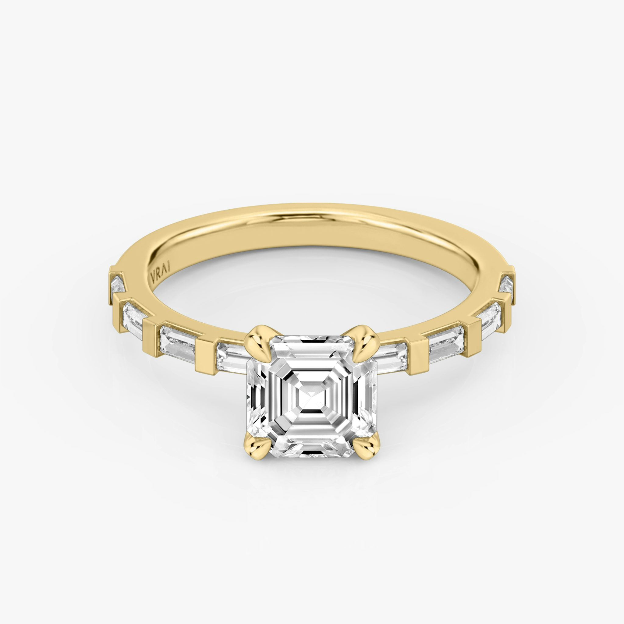 The Baguette Bar Asscher Yellow Gold Engagement Ring laying flat.