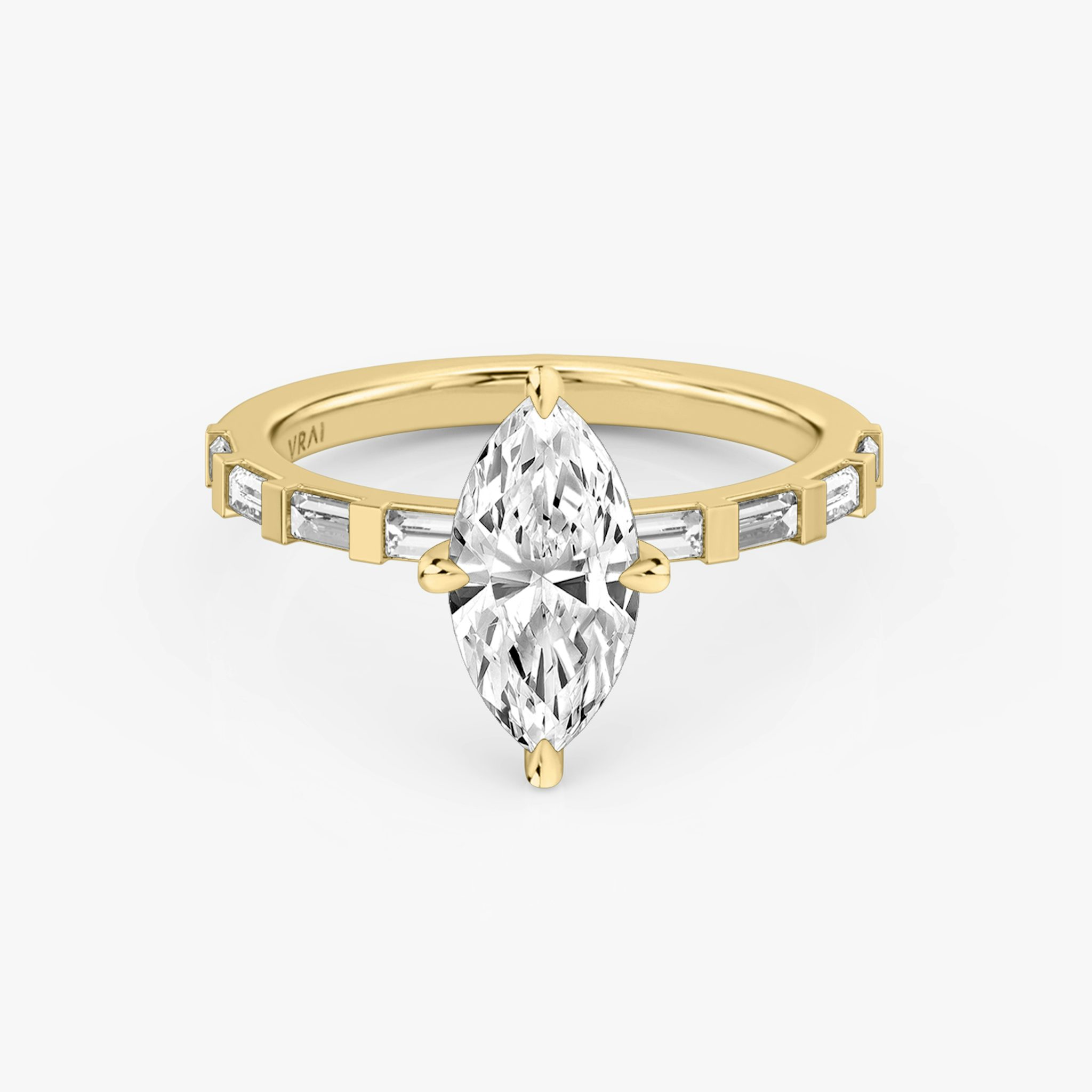 The Baguette Bar Marquise Yellow Gold Engagement Ring laying flat.