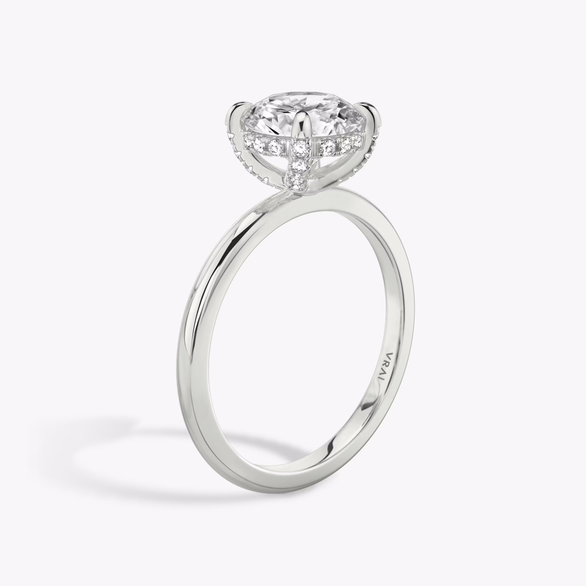 The Classic Hidden Halo | Round Brilliant | Platinum | bandAccent: Plain | bandWidth: standard | caratWeight: other | prongStyle: Pavé | diamondOrientation: vertical