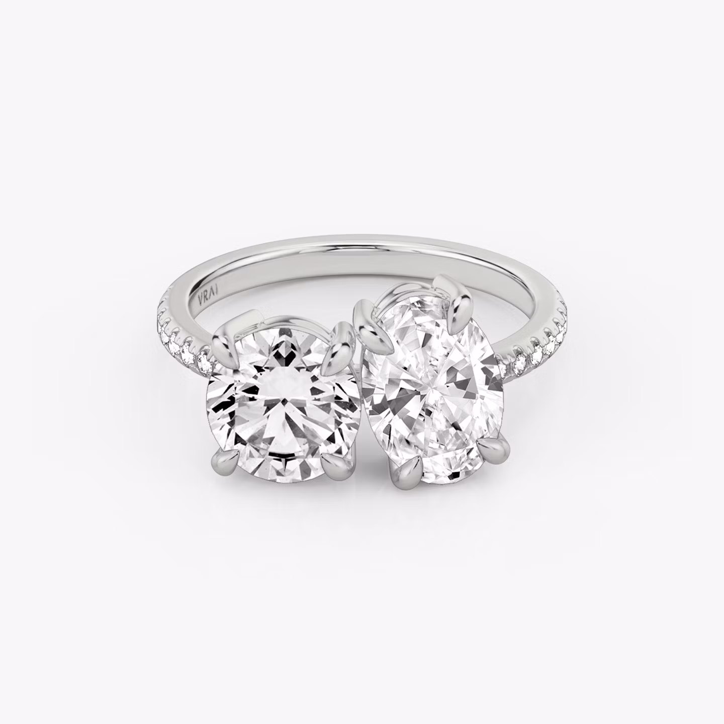 A Toi et Moi-style engagement ring with a white gold band.