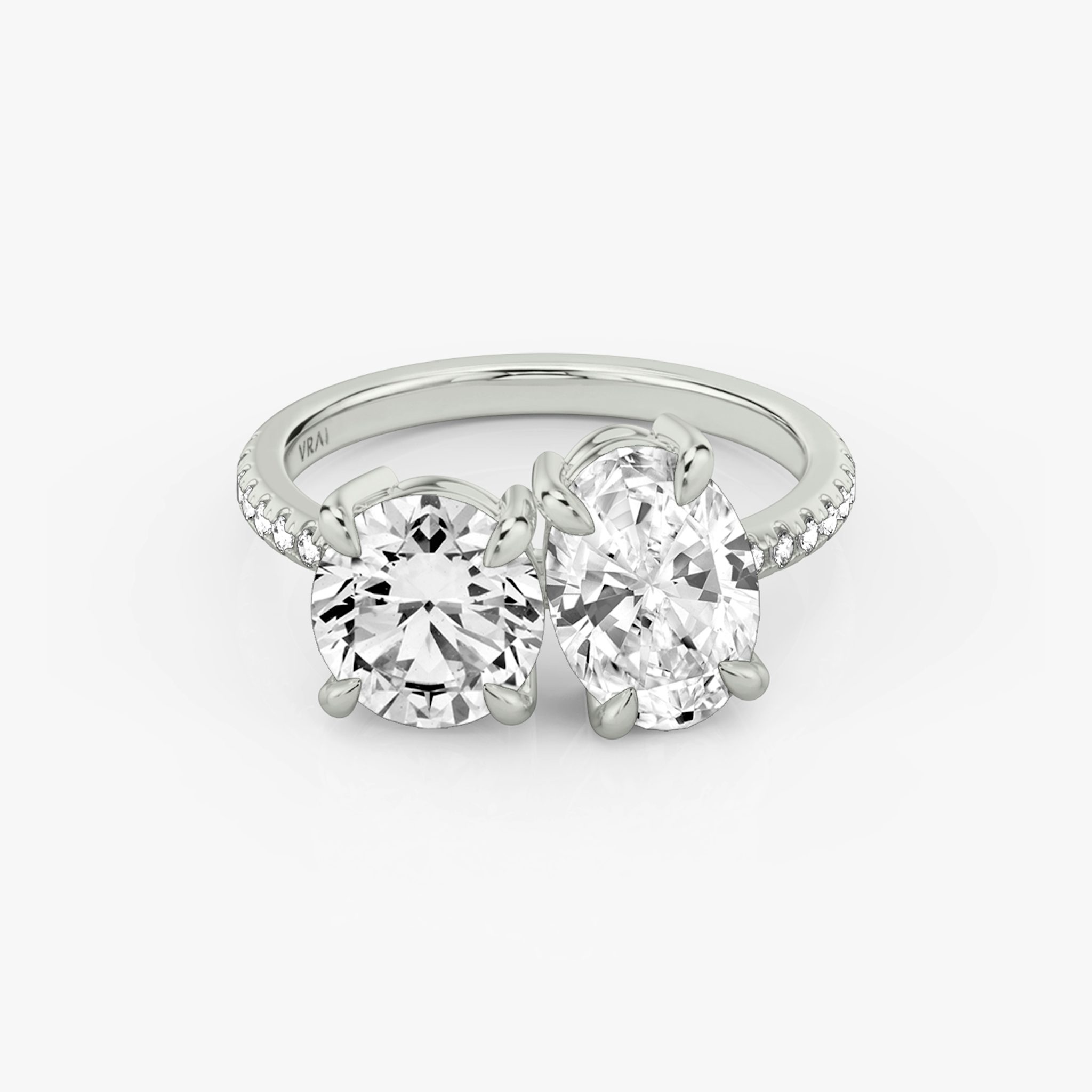 A Toi et Moi-style engagement ring with a white gold band.