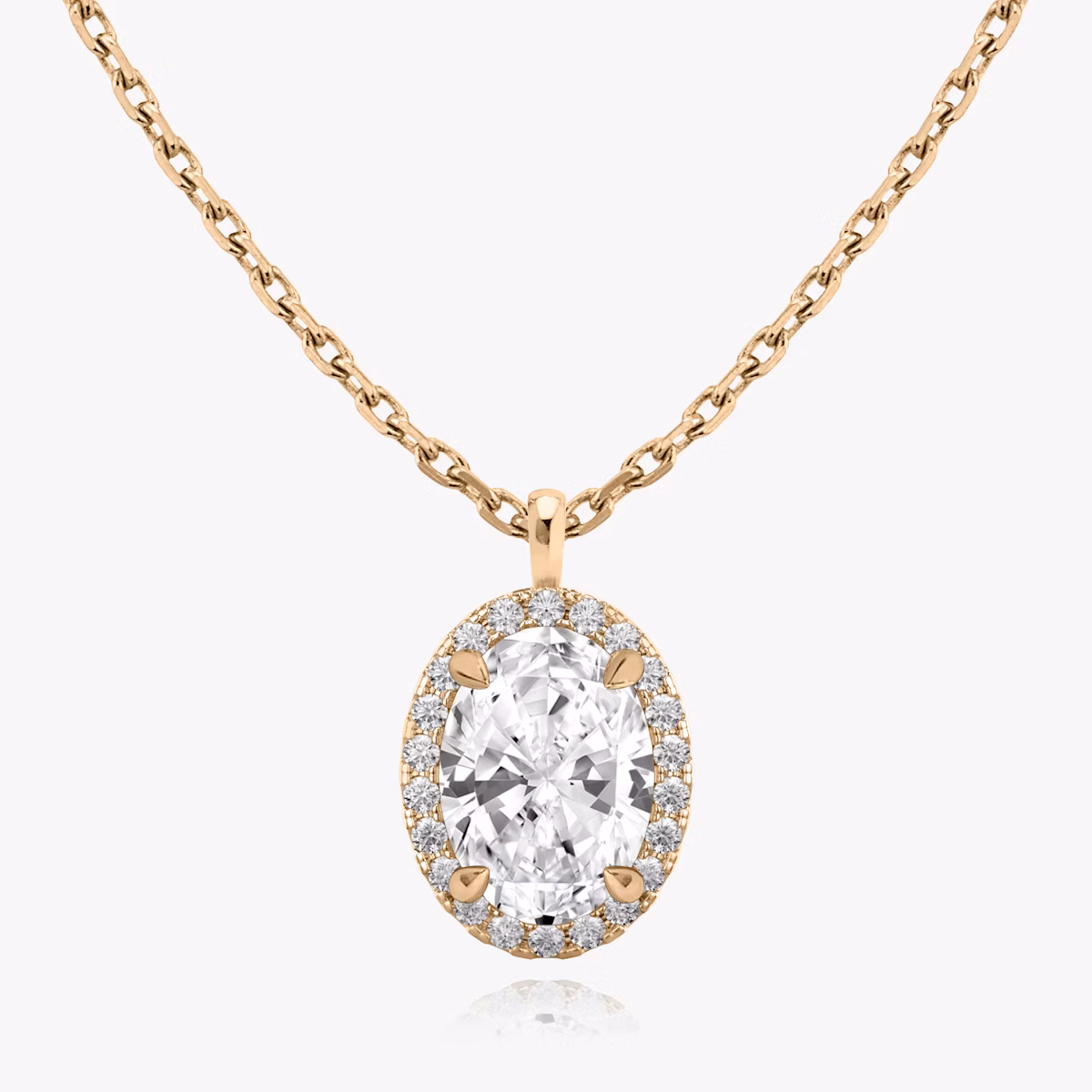 Close-up of a chain necklace with an oval halo diamond pendant in rose gold.