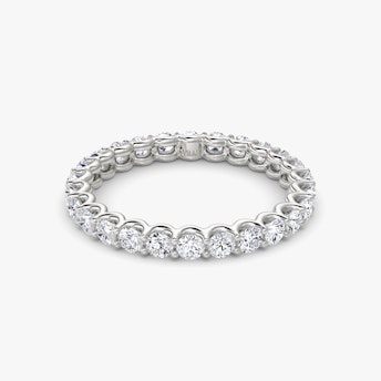 Platinum eternity band with round brilliant-cut diamonds in a scalloped setting, shown on white background.