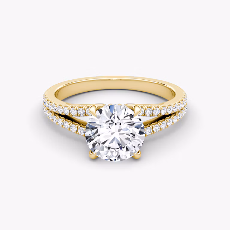 Un anillo de compromiso de oro con diamantes redondos.