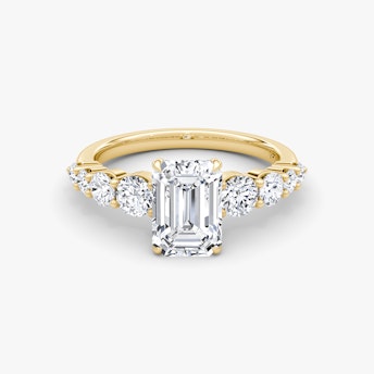 The Graduated Band Emerald Yellow Gold Engagement Ring.