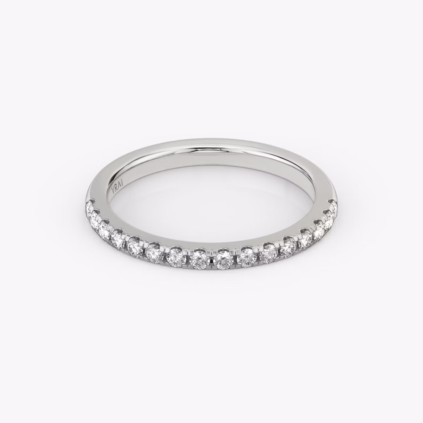 White gold pavé ring with pear-cut center diamond and halo setting, shown on white background.