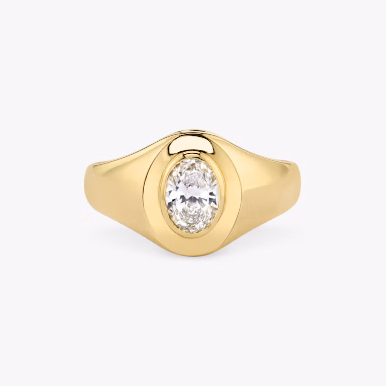 Front view of an oval signet ring in oval yellow gold on a white background