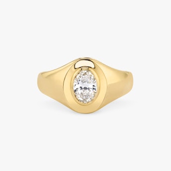 Front view of an oval signet ring in oval yellow gold on a white background