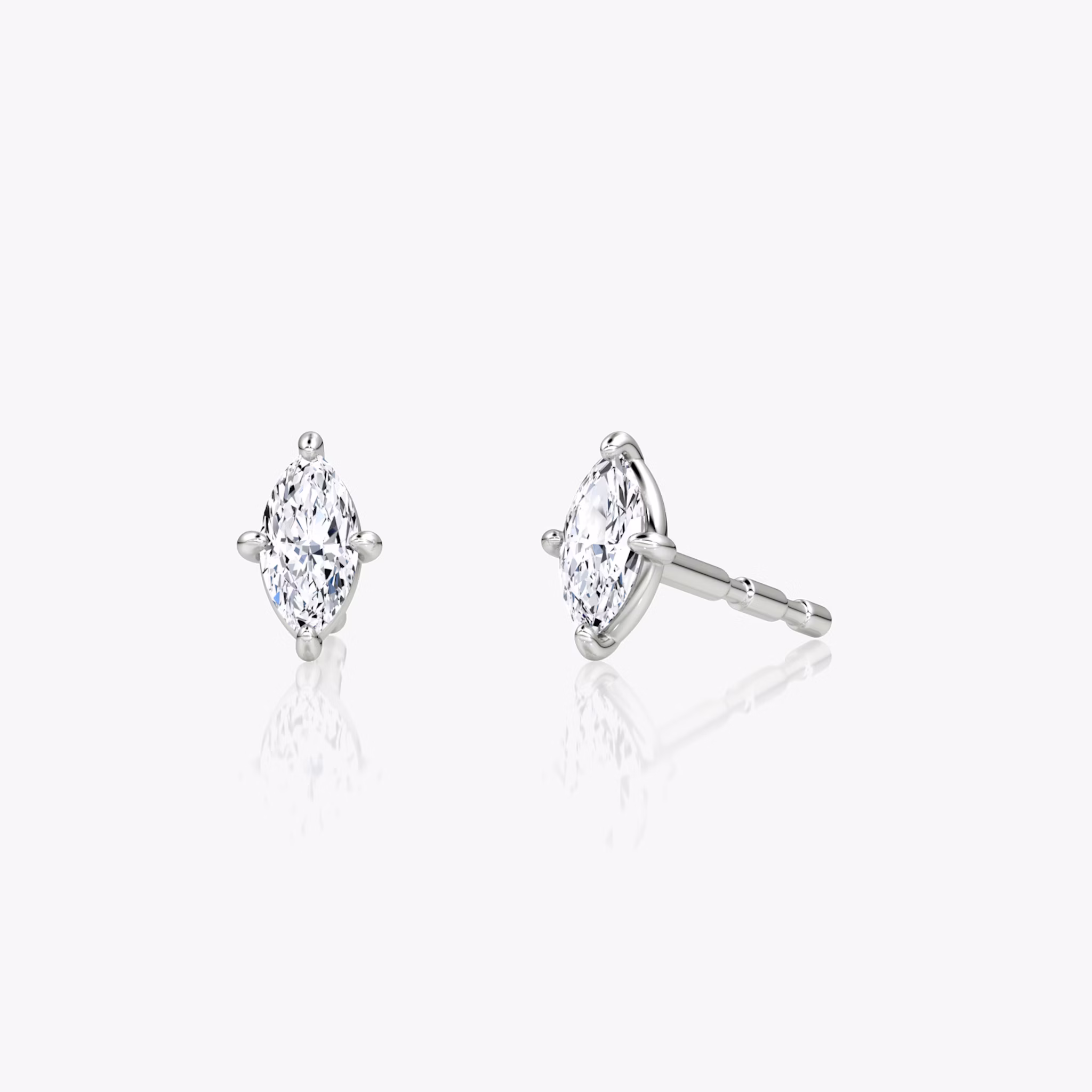A pair of Petite Solitaire Studs in sterling silver or white gold.