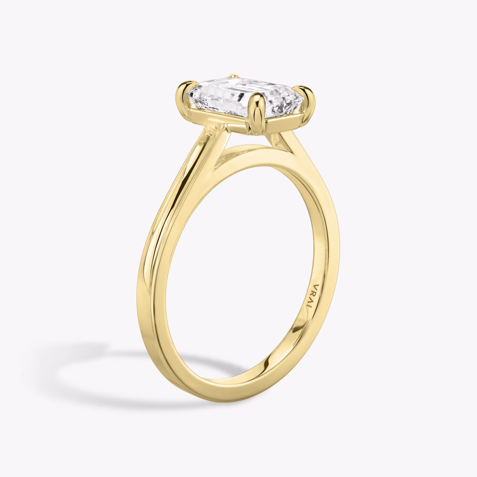 A close-up image of VRAI's Cathedral Emerald Yellow Gold Engagement Ring, standing upright.