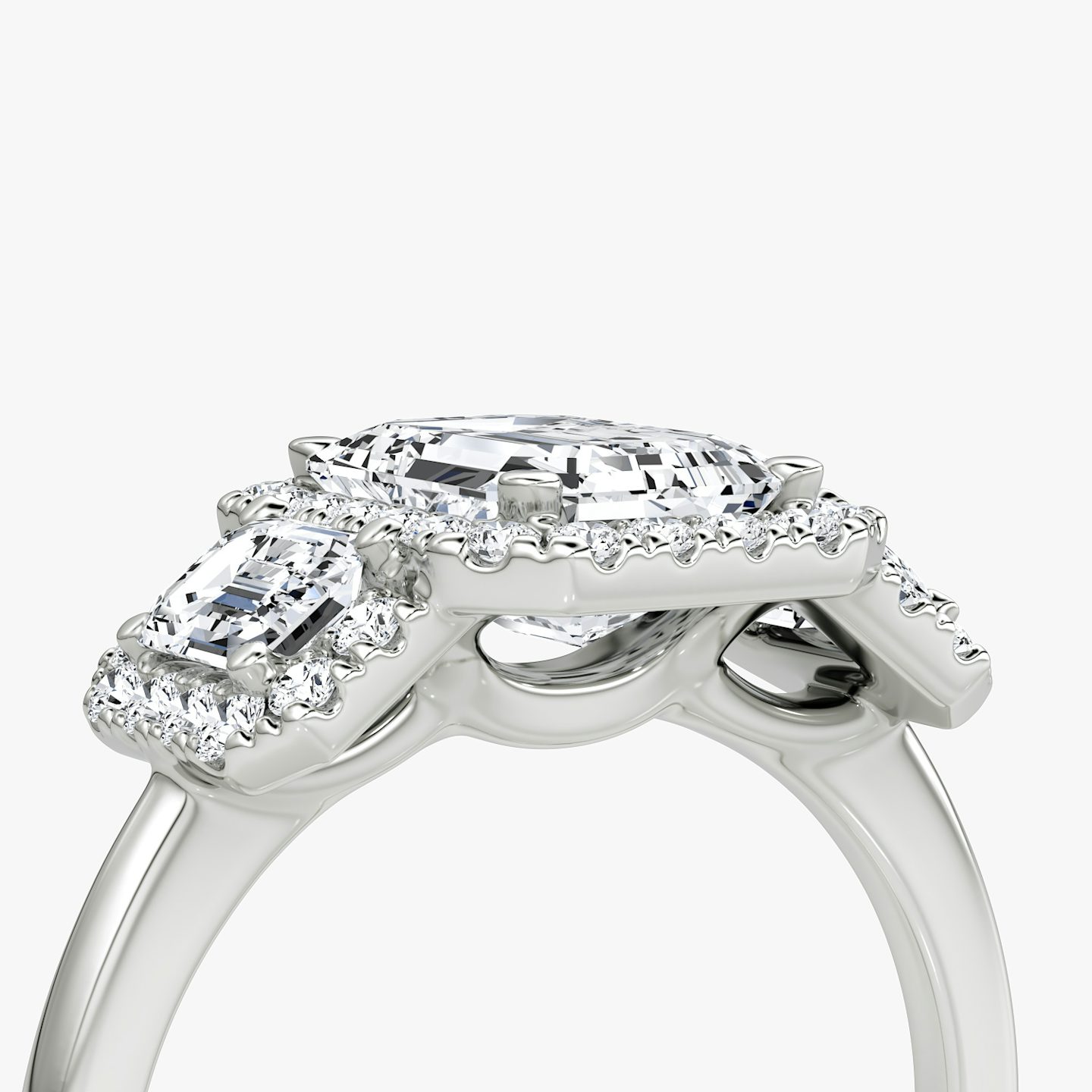 The Three Stone Halo | Emerald | Platinum | bandAccent: Plain | sideStoneCarat: 0.25ct | diamondOrientation: vertical | caratWeight: other