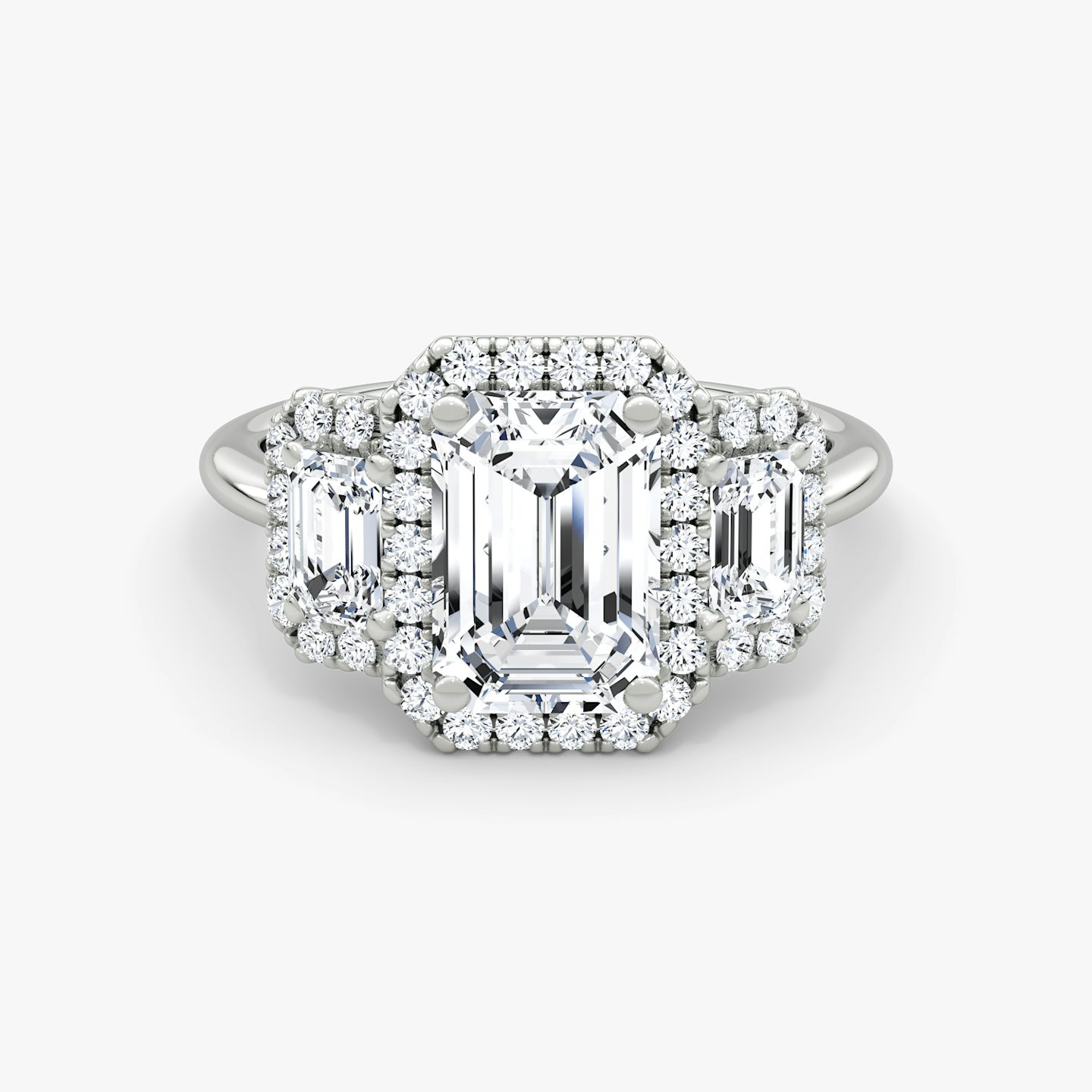 The Three Stone Halo | Emerald | Platinum | bandAccent: Plain | sideStoneCarat: 0.25ct | diamondOrientation: vertical | caratWeight: other