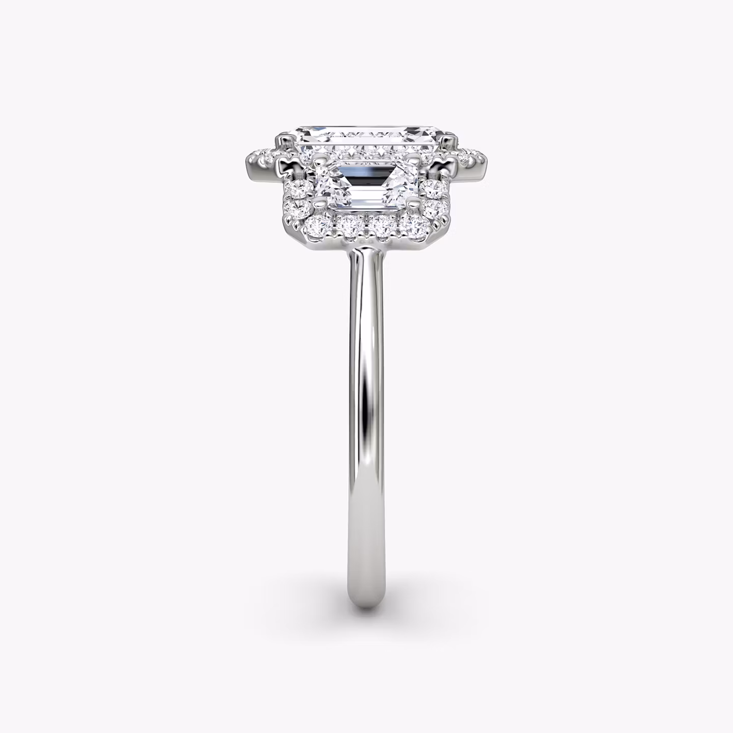 The Three Stone Halo | Emerald | Platinum | bandAccent: Plain | sideStoneCarat: 0.25ct | diamondOrientation: vertical | caratWeight: other