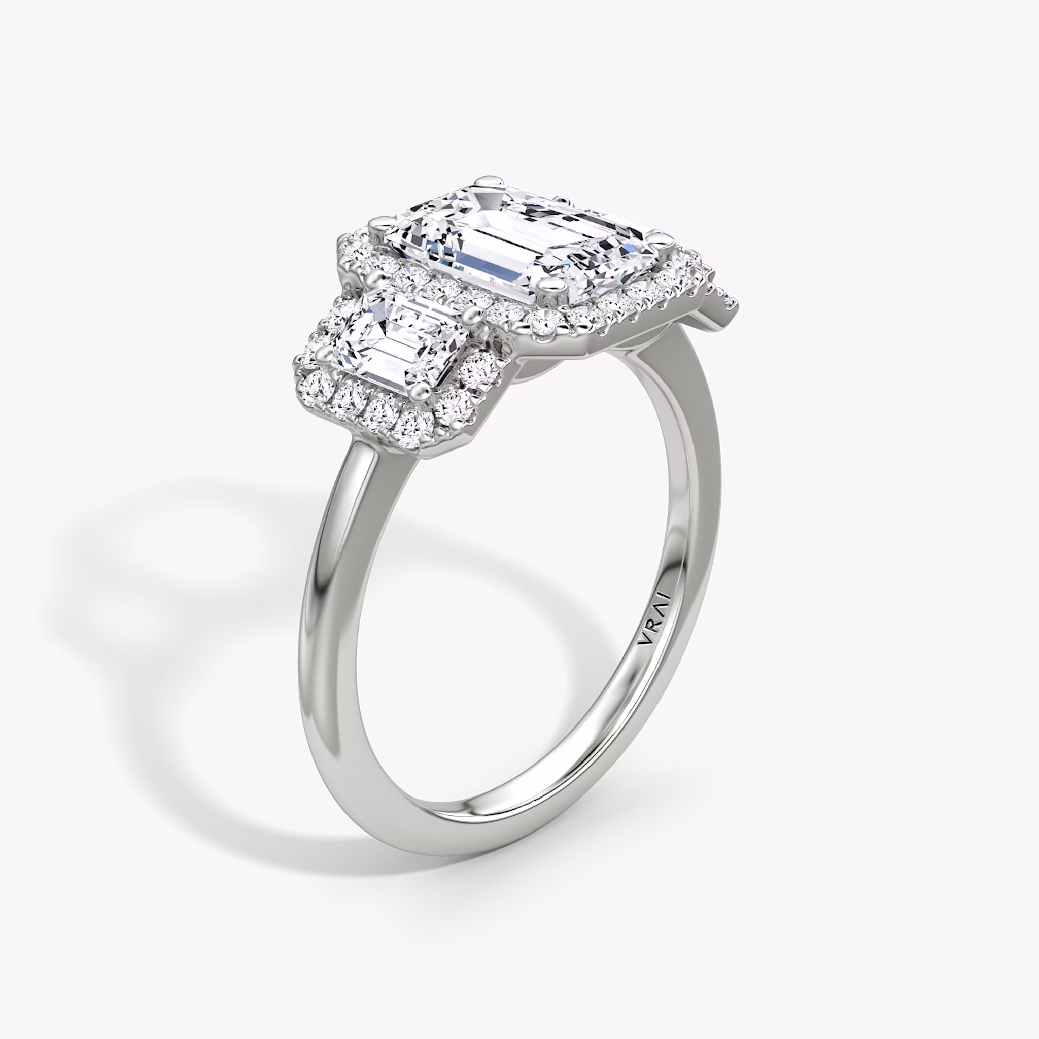 The Three Stone Halo | Emerald | 18k | White Gold | bandAccent: Plain | sideStoneCarat: 0.25ct | diamondOrientation: vertical | caratWeight: other