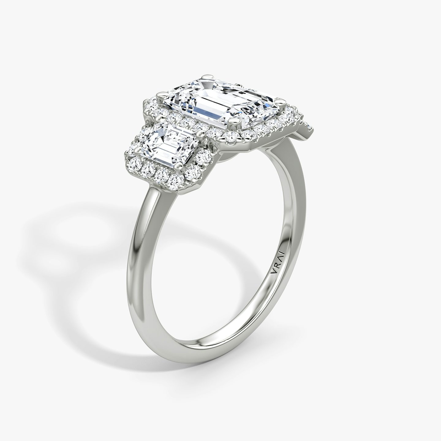 The Three Stone Halo | Emerald | Platinum | bandAccent: Plain | sideStoneCarat: 0.25ct | diamondOrientation: vertical | caratWeight: other