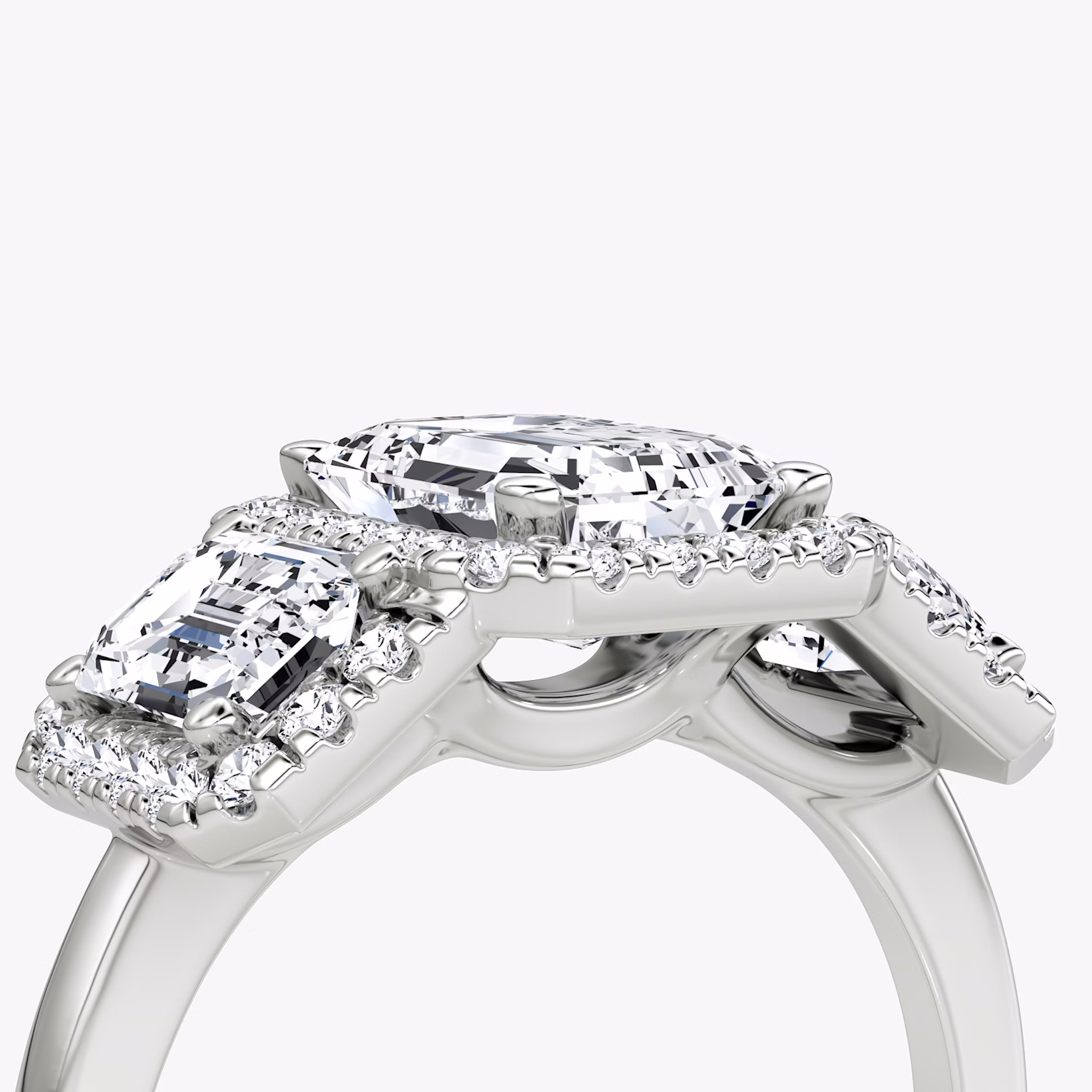 The Three Stone Halo | Emerald | Platinum | bandAccent: Plain | sideStoneCarat: 0.50ct | diamondOrientation: vertical | caratWeight: other