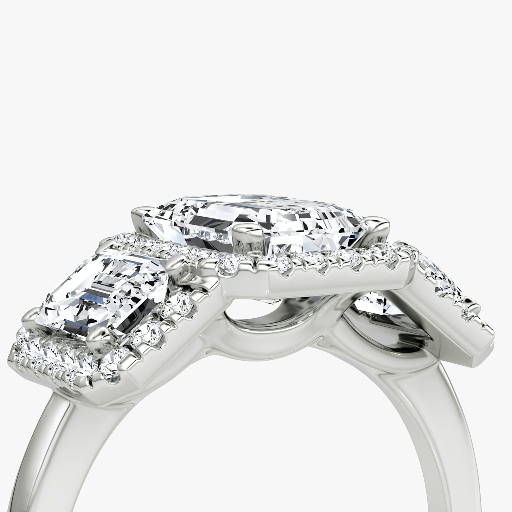 The Three Stone Halo | Emerald | Platinum | bandAccent: Plain | sideStoneCarat: 0.50ct | diamondOrientation: vertical | caratWeight: other