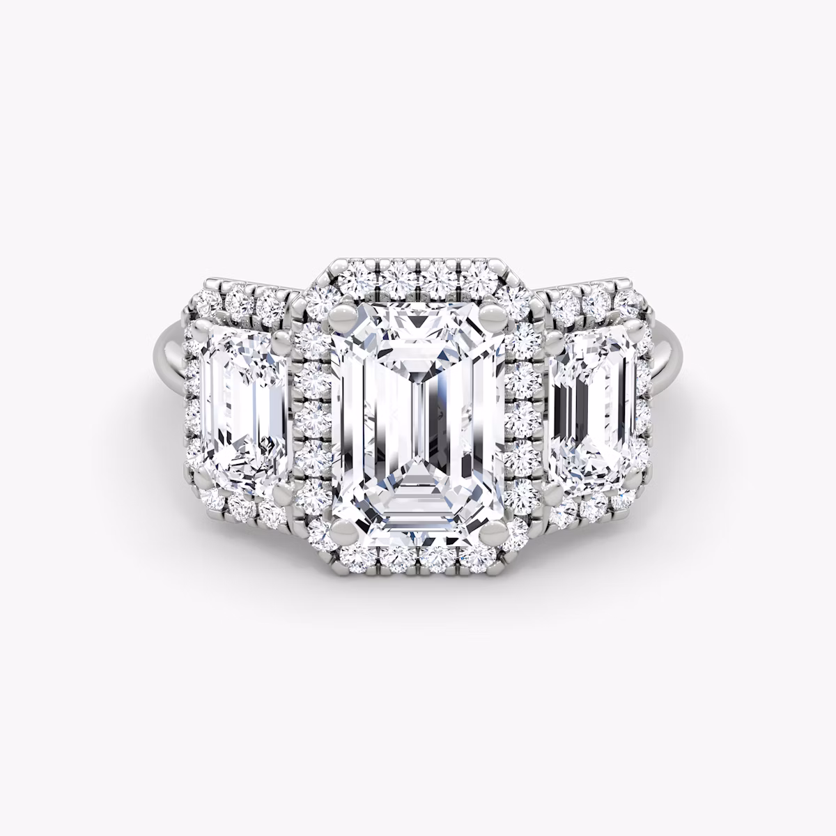 The Three Stone Halo | Emerald | Platinum | bandAccent: Plain | sideStoneCarat: 0.50ct | diamondOrientation: vertical | caratWeight: other