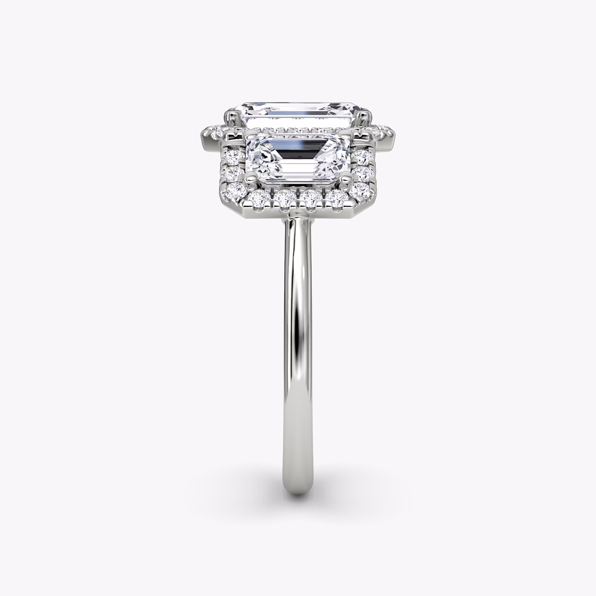 The Three Stone Halo | Emerald | Platinum | bandAccent: Plain | sideStoneCarat: 0.50ct | diamondOrientation: vertical | caratWeight: other