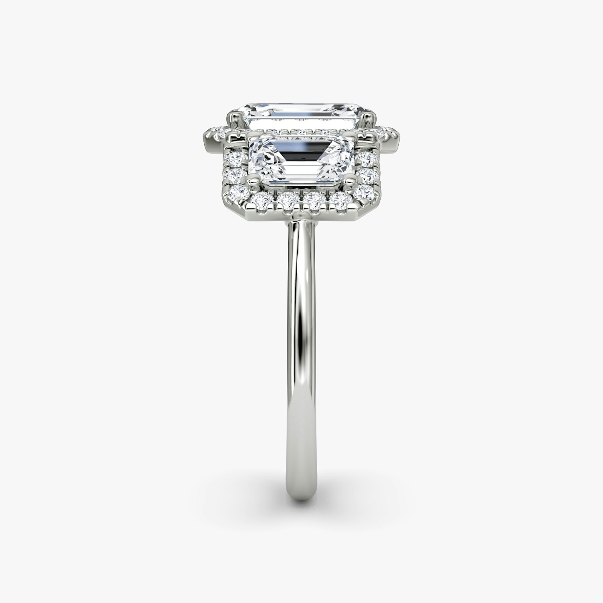 The Three Stone Halo | Emerald | Platinum | bandAccent: Plain | sideStoneCarat: 0.50ct | diamondOrientation: vertical | caratWeight: other