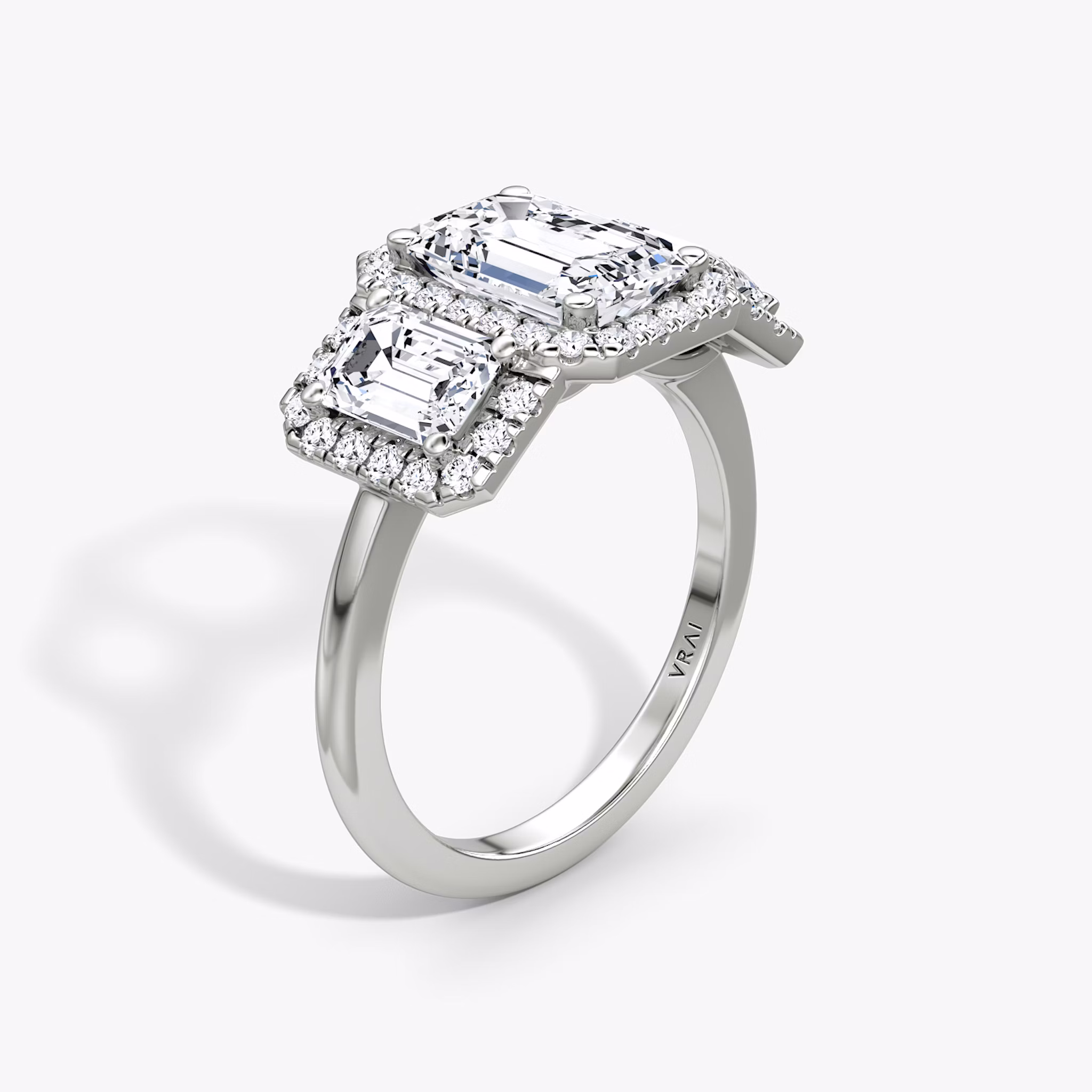 The Three Stone Halo | Emerald | Platinum | bandAccent: Plain | sideStoneCarat: 0.50ct | diamondOrientation: vertical | caratWeight: other